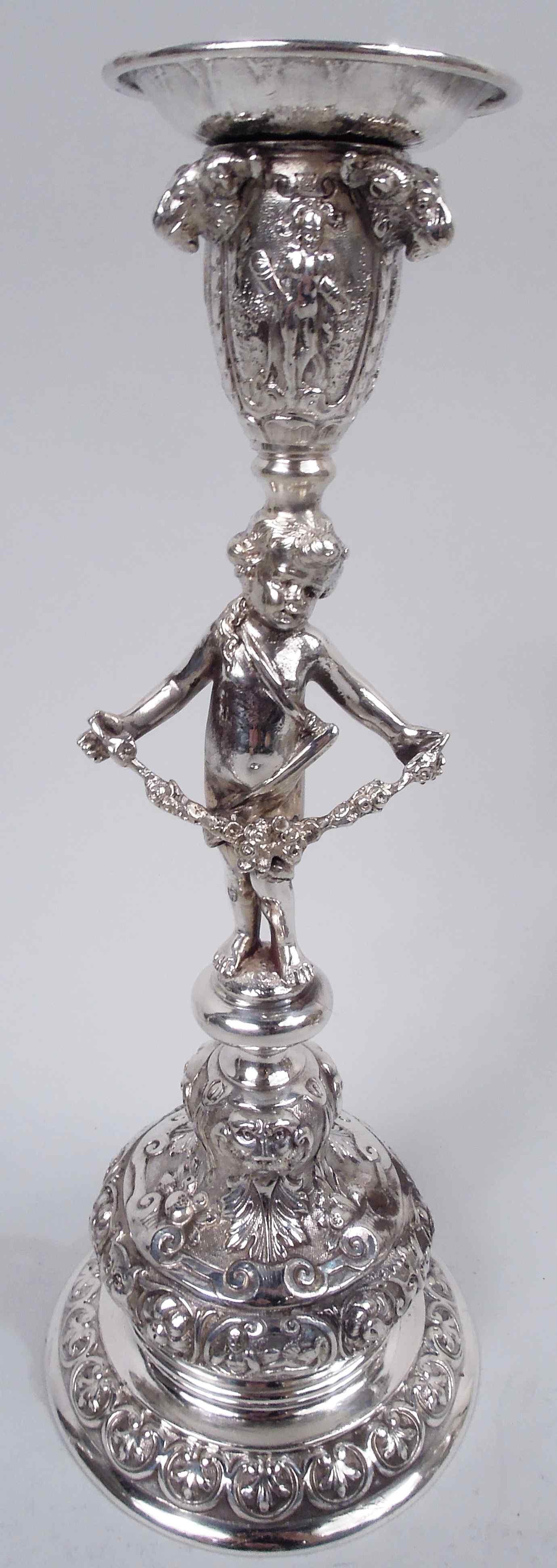 Set of 4 German Rococo Classical 800 silver candlesticks, ca 1900. Each: Cast figural shaft in form of adroitly-draped, bare-bottomed cherub standing on chubby, stubby legs with arms outspread, holding a floral garland. Ovoid socket with detachable