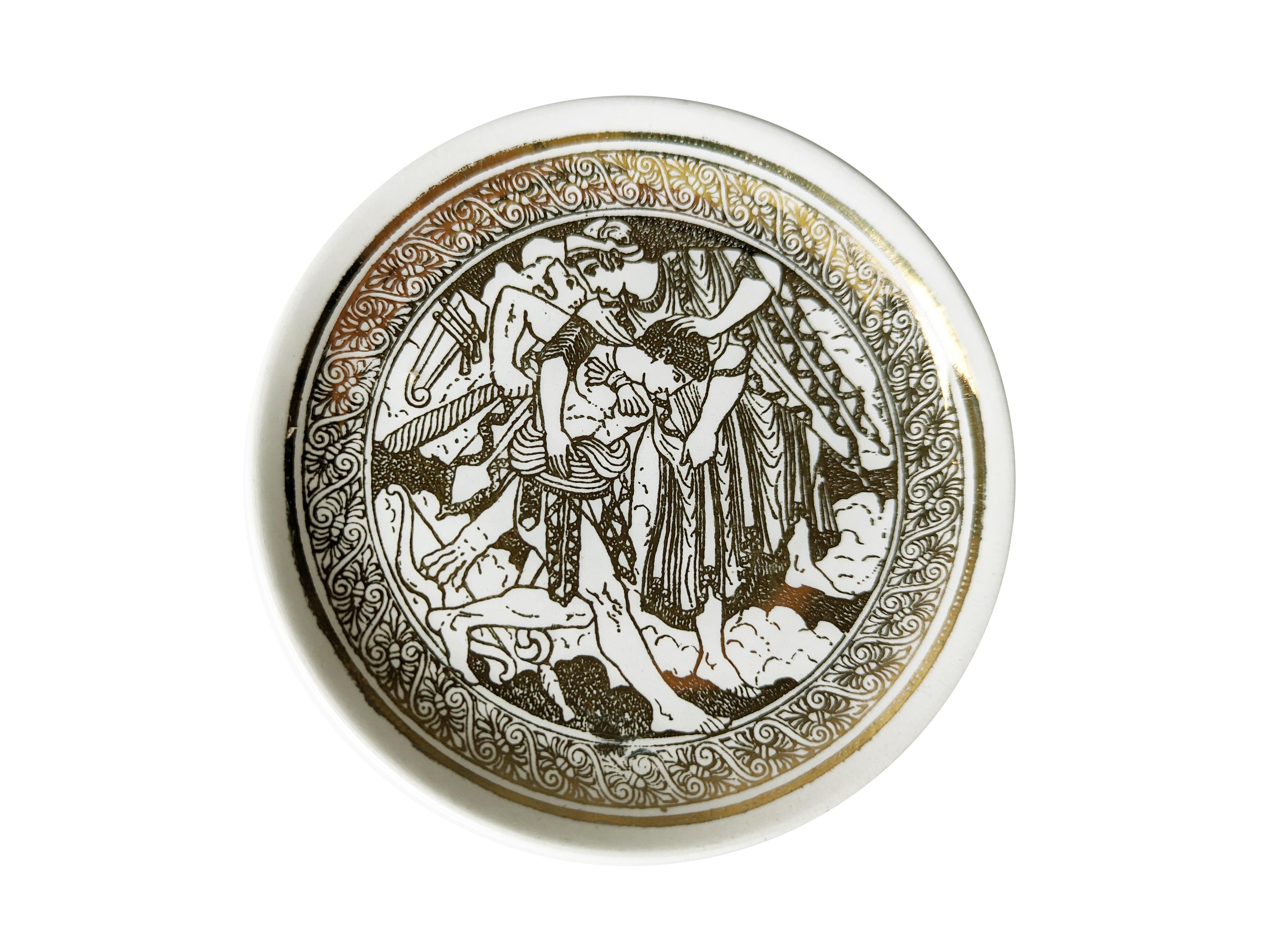 This Fornasetti Mitologia set includes four 4 inch (10.5 cm) coasters, . These are in very good condition considering their age, with slight fading of the gold and some very light scratches.
Each piece with gilt Greco Roman allegorical scene