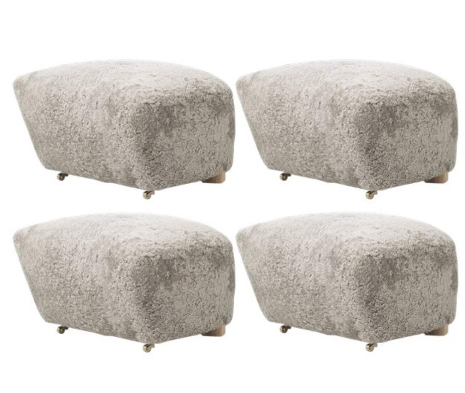 Set of 4 green tea natural oak sheepskin the tired man footstools by Lassen.
Dimensions: W 55 x D 53 x H 36 cm
Materials: Sheepskin

Flemming Lassen designed the overstuffed easy chair, The Tired Man, for The Copenhagen Cabinetmakers’ Guild