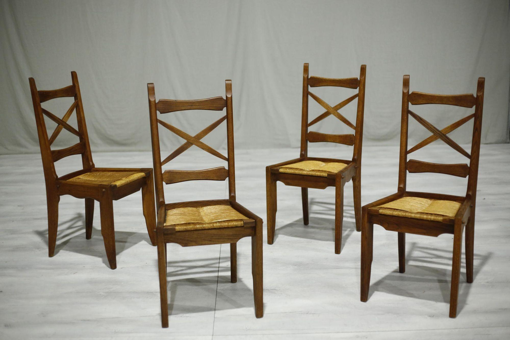 These are a beautiful quality set of French mid century dining chairs designed by the renowned Guillerme et Chambron.

These chairs are in gorgeous original condition with no major issues. The rush seats are in perfect order meaning these are fine