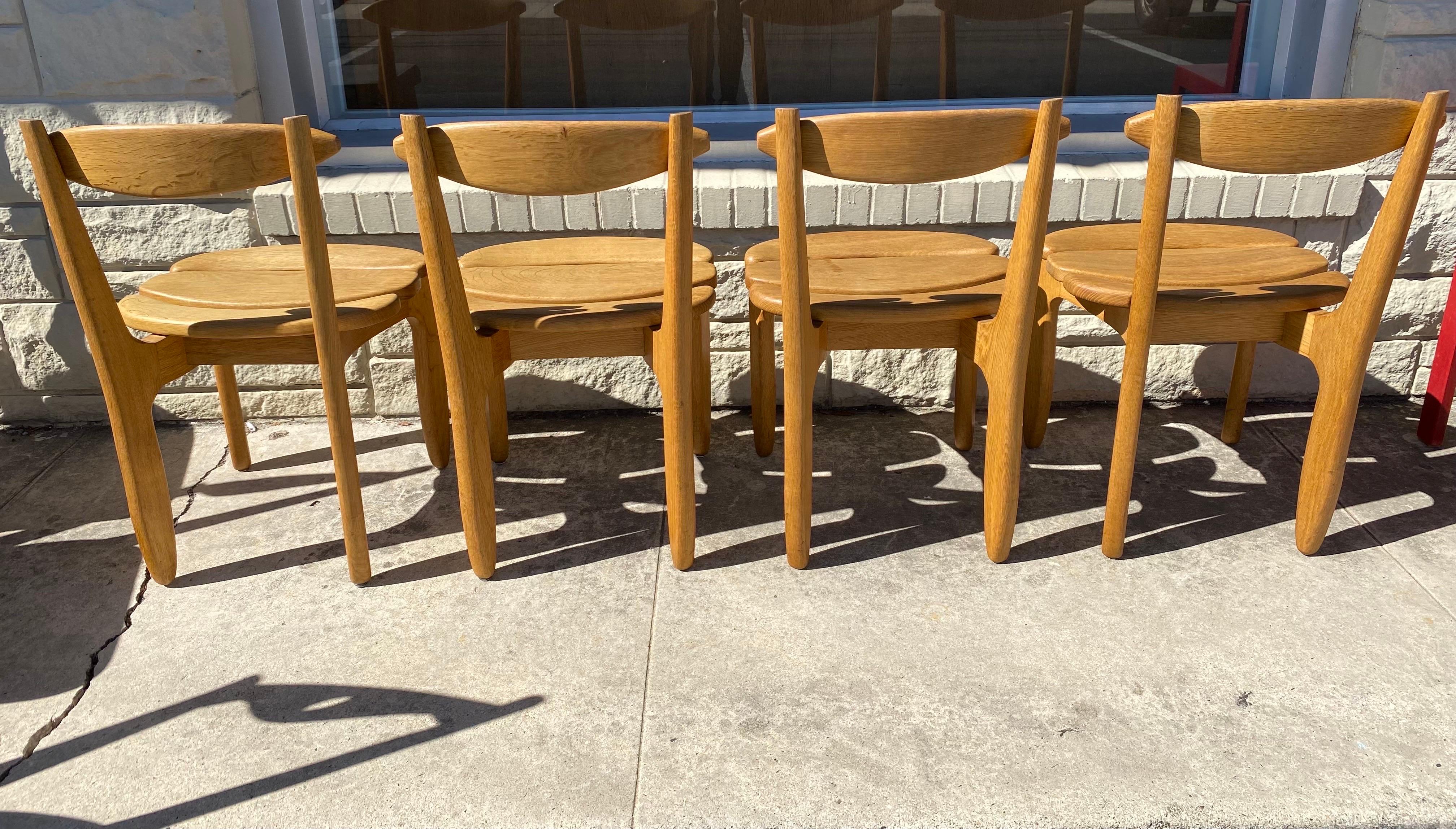 Set of 4 brutalist modern Guillerme et Chambron dining chairs made of solid oak, circa 1960s, France. 
Dimensions: 18.50