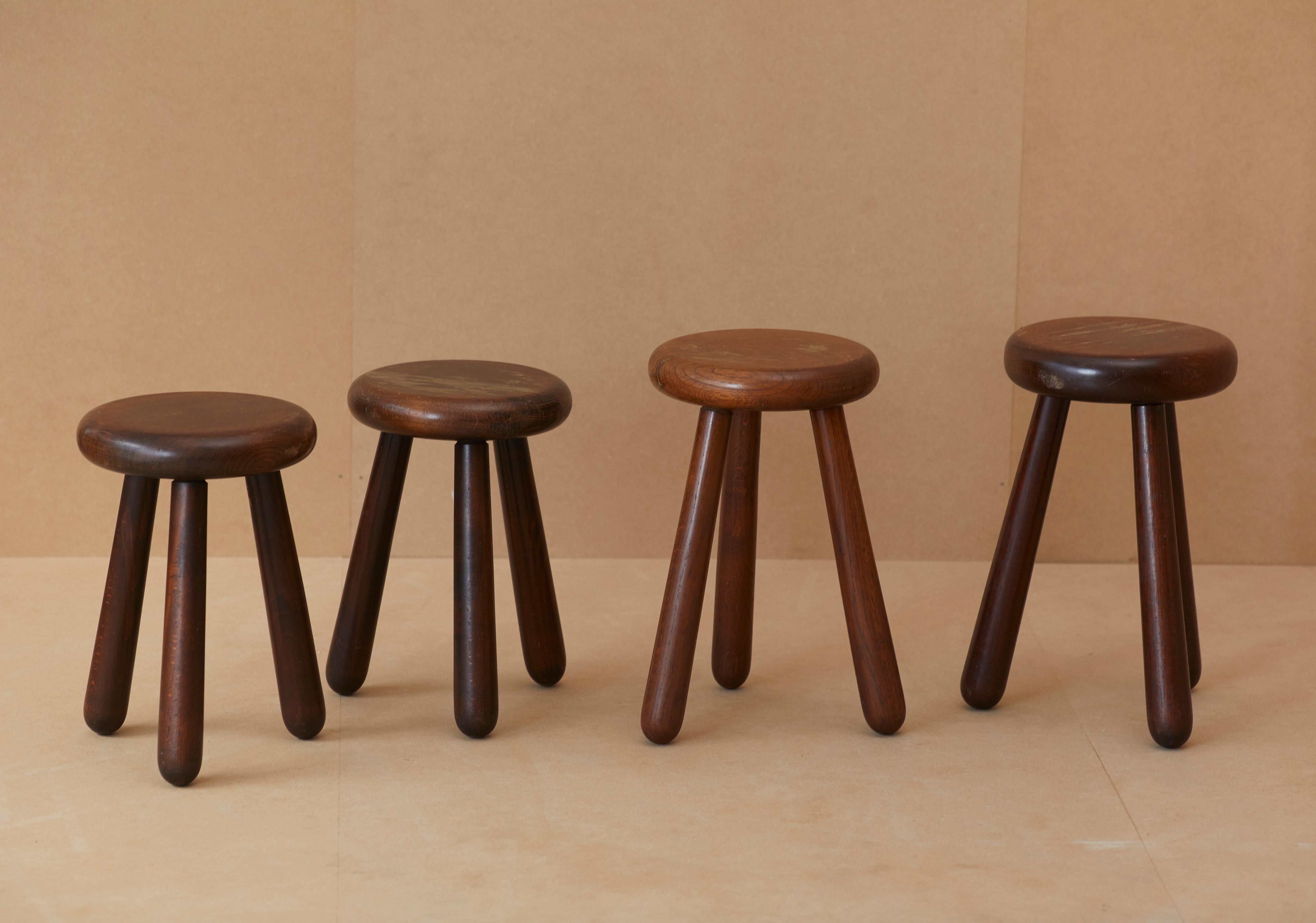 Set of (4) heavy, handcrafted, solid wood stools with dovetail joinery details. France, circa 1970.

The tallest stool is made of solid oak and the three others are made of solid beech. 

They were acquired from their maker, Leon, a 91-year old