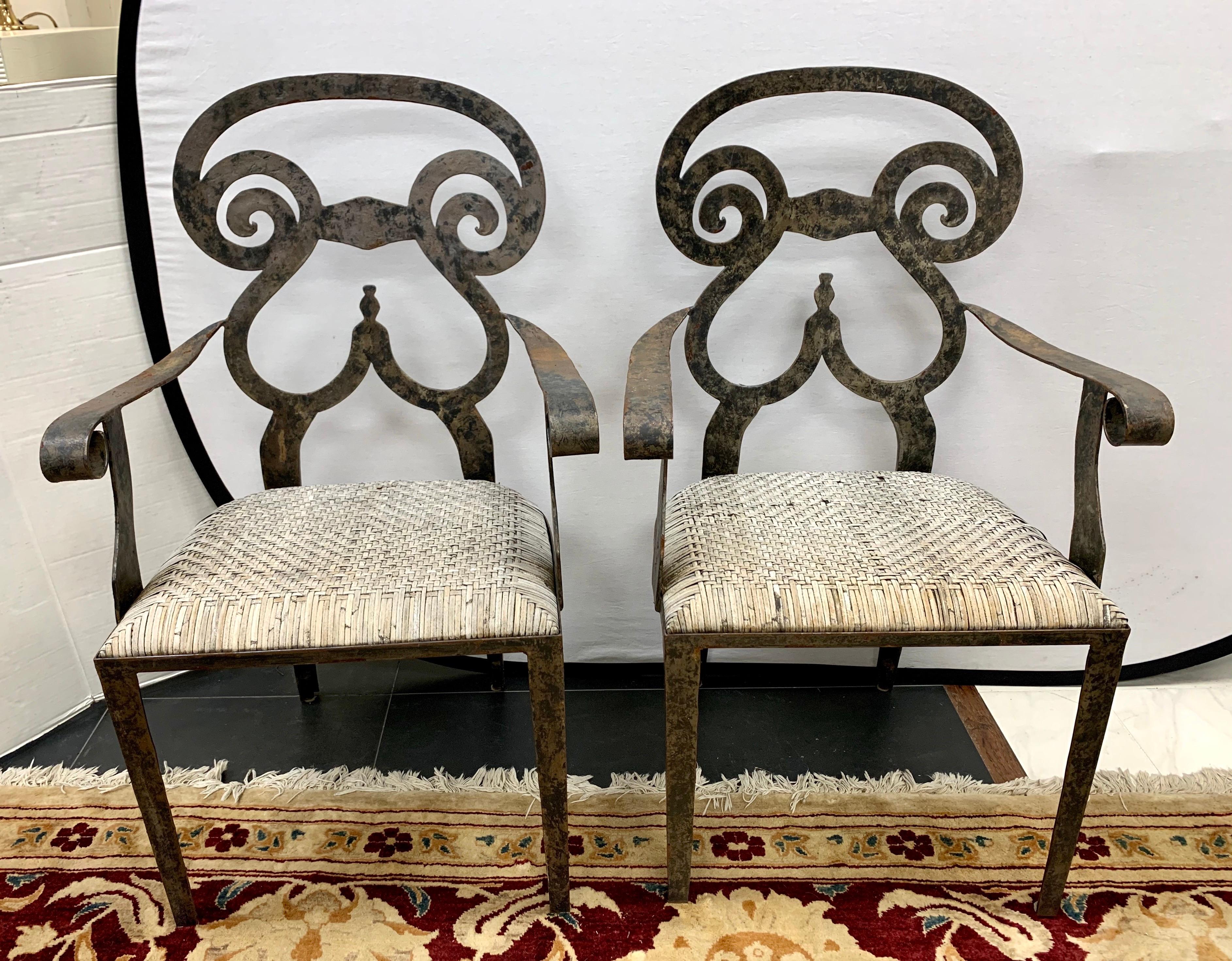 Set of 4 artisan cast iron patio chairs, 2 sides and 2 armchairs. Features round sculptural backs and woven rattan seats.
Measures: Side chairs 36” H x 21”D x 19” W
Armchairs 36” H x 21” D x 22” W.