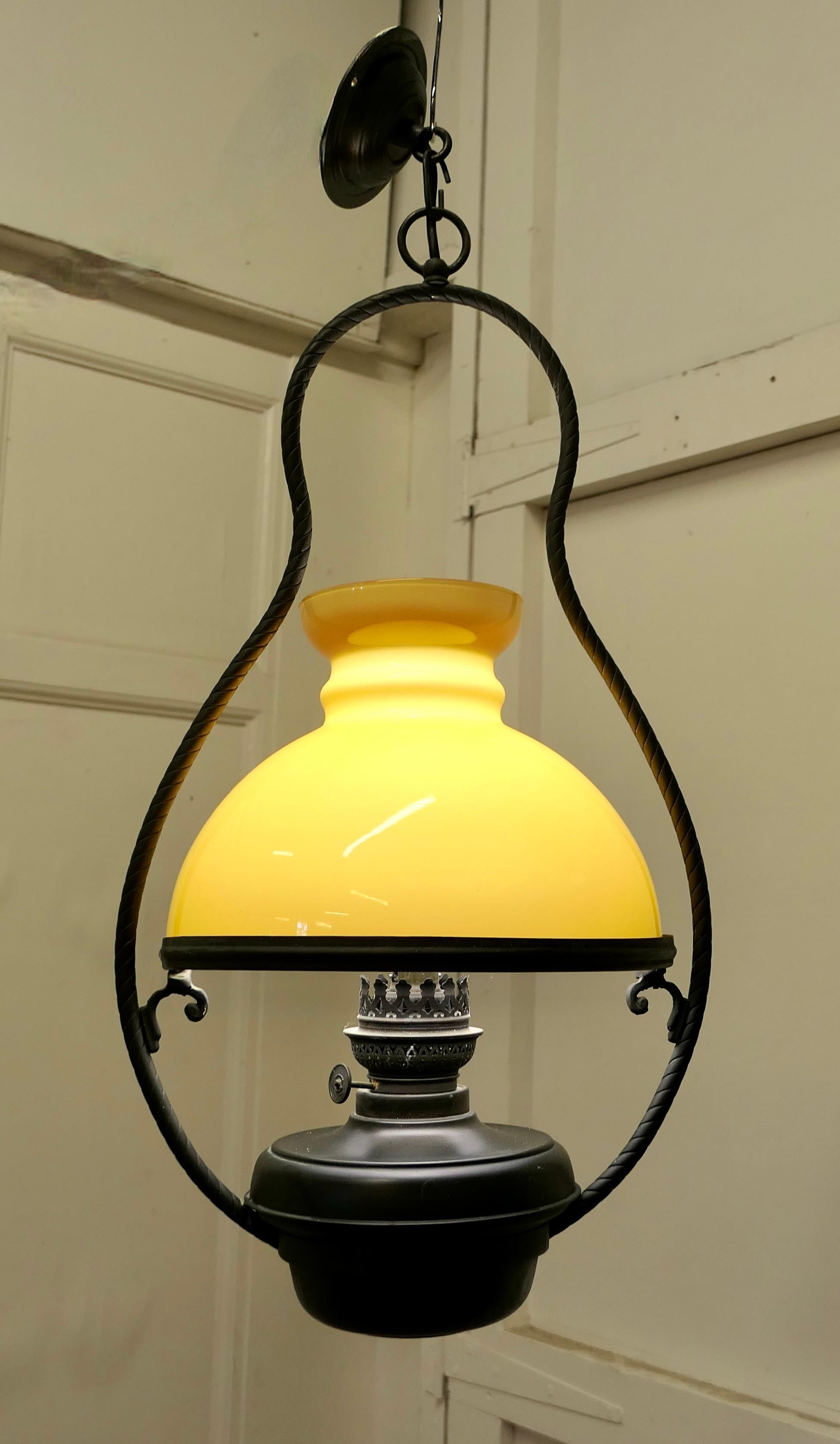Set of 4 Hanging Bistro table oil lamps 

These were formerly oil lamps they have been converted for electricity, the style is a classic and would work well with a bistro table
The frame of the lamp is in brass with mustard Yellow hand blown