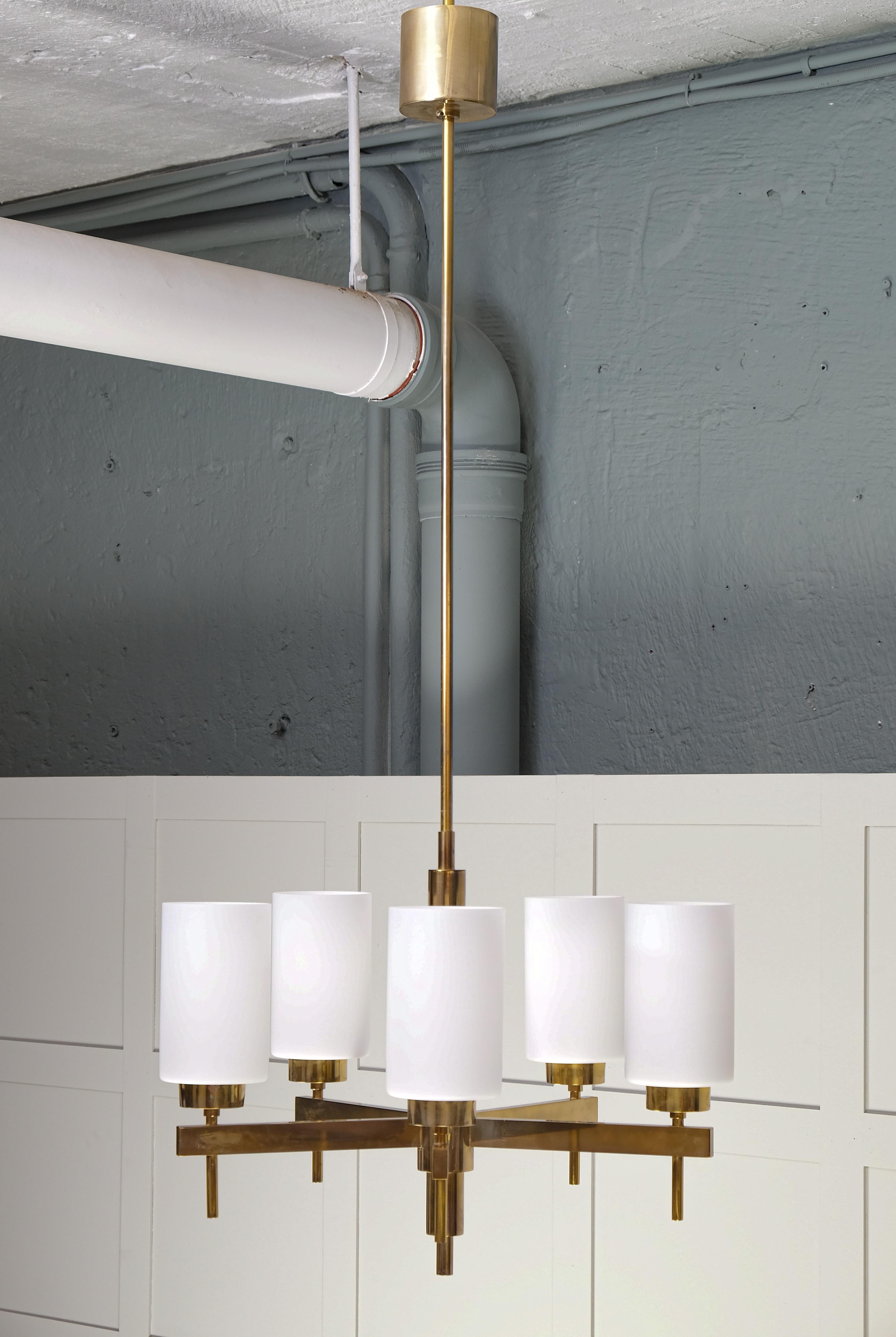 Listed price is for a one (1) chandelier. 
Opaline glass and brass. Designed by Hans-Agne Jakobsson and produced by Hans-Agne Jakobsson AB in Markaryd, Sweden, 1960s. 
Measurements: 
Height 135 cm (Can be shortened/extended up on