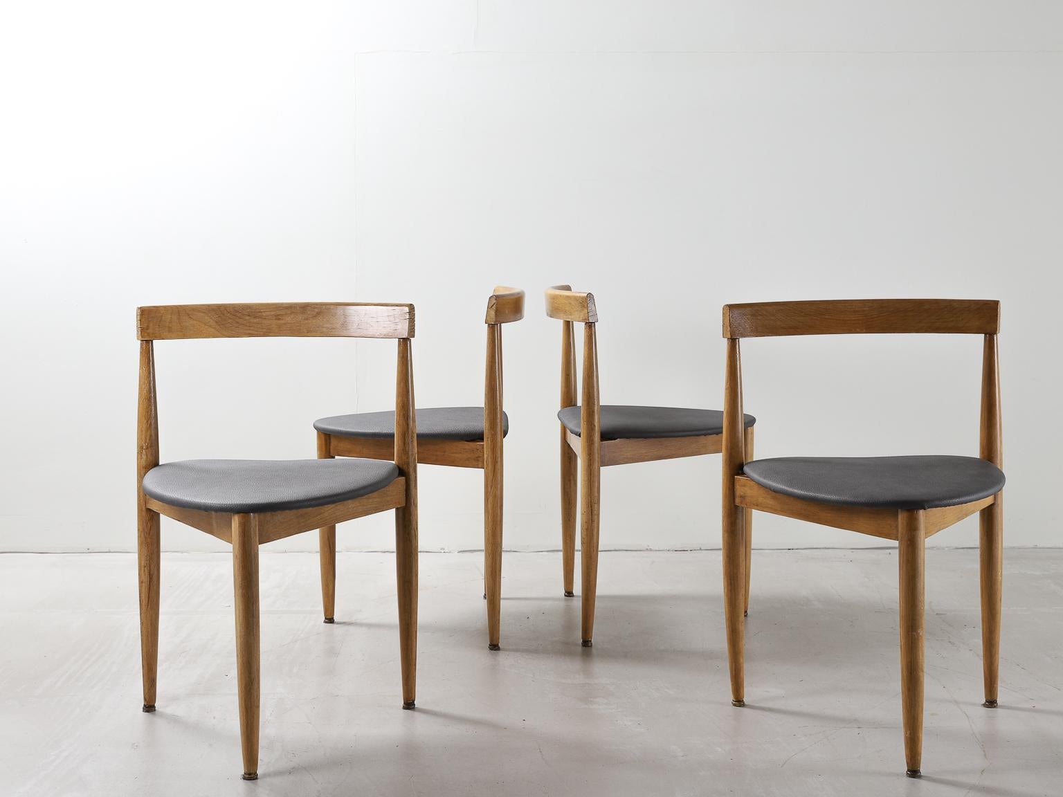 A set of four wood and leather side or dining chairs designed and made in Denmark by Hans Olsen for manufacturer Frem Røjle. 

Leather has been reupholstered to in a green leather. 

Hans Olsen (1919-1992) was a Danish furniture designer who