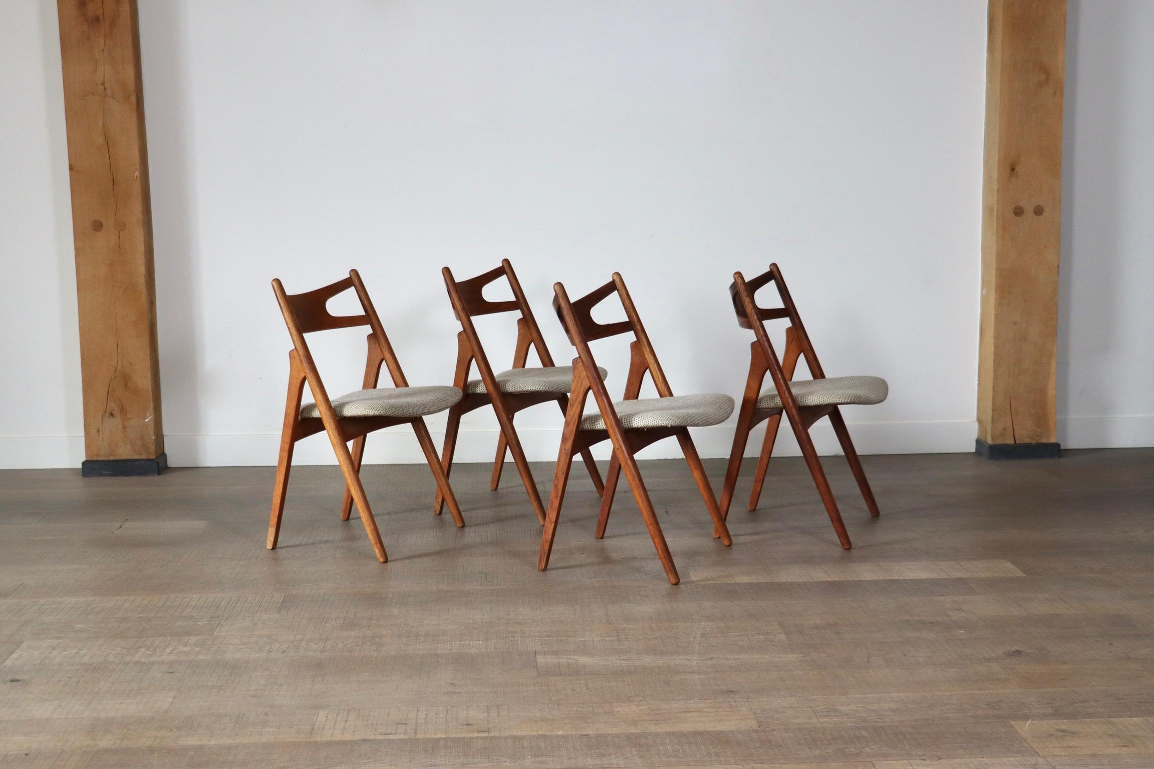 Nice set of 4 iconic model CH29 dining chairs designed by Hans J. Wegner and manufactured by Carl Hansen & Søn, Denmark 1952. This design classic is also called “Sawbuck chair” because the model resembles a sawhorse. The sawhorse was traditionally