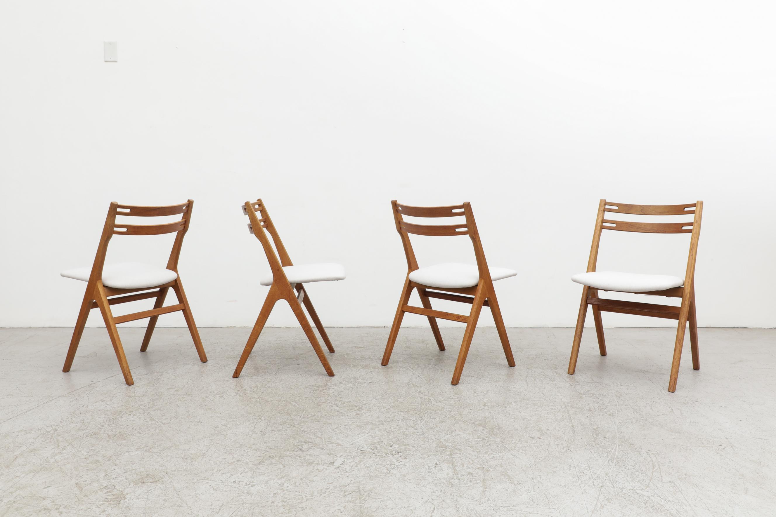 Set of 4 Hans Wegner style oak dining chairs with compass legs and a slightly bowed backrest by the Danish company Sibast, a Danish family company with a proud history of wooden furniture making dating back to 1908. These are in original condition