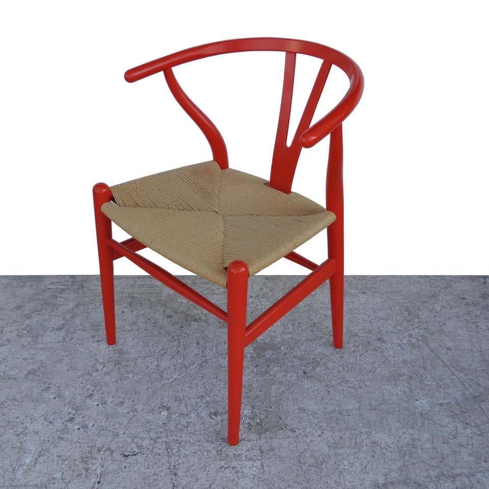 Set of 4 Hans Wegner Wishbone chairs by Carl Hansen

 Hans J. Wegner, 1949

The Wishbone chair is a triumph of craftsmanship and one of Hans Wegner's most celebrated works. 
Lacquered in a bright red/orange with a hand-woven seat in natural