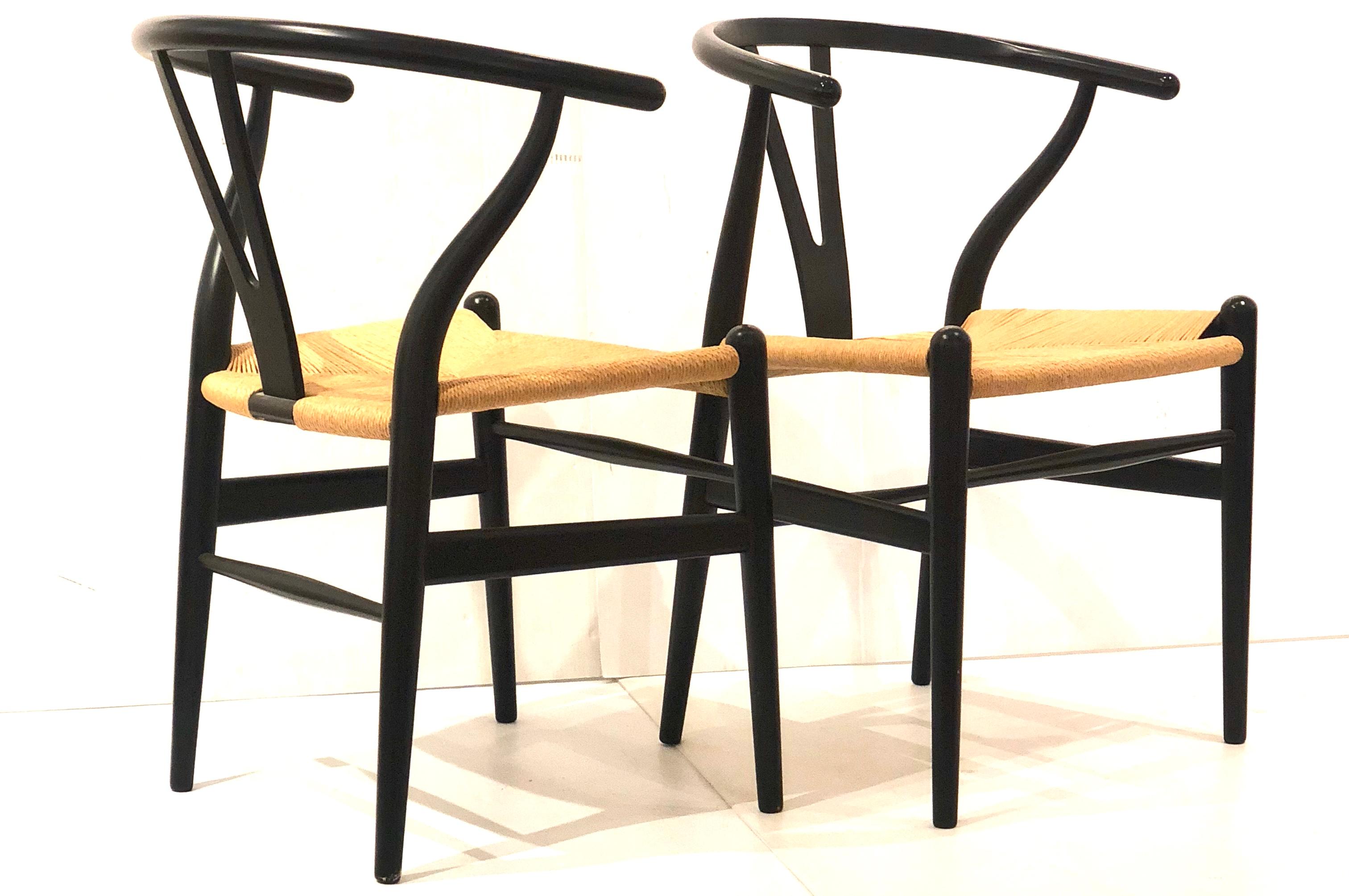 Great set of 4 Hans Wegner wishbone chairs, in beech in black satin finish, with natural woven paper cord, CH24 model , very nice and clean condition 20 years old approx and hardly ever used, solid and sturdy.
