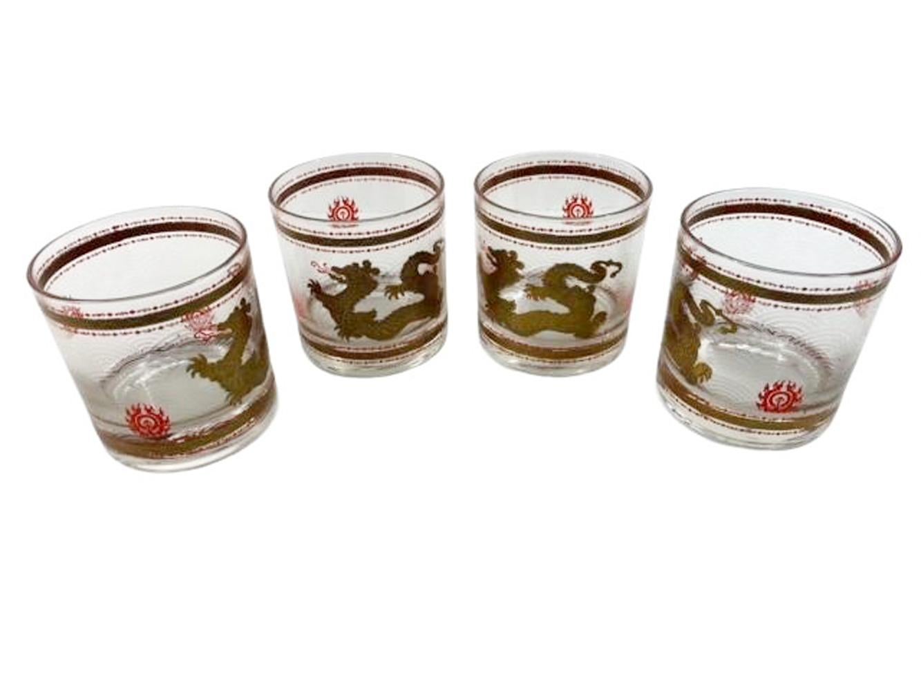 Four vintage rocks glasses by Cera with a Golden Dragon chasing the 