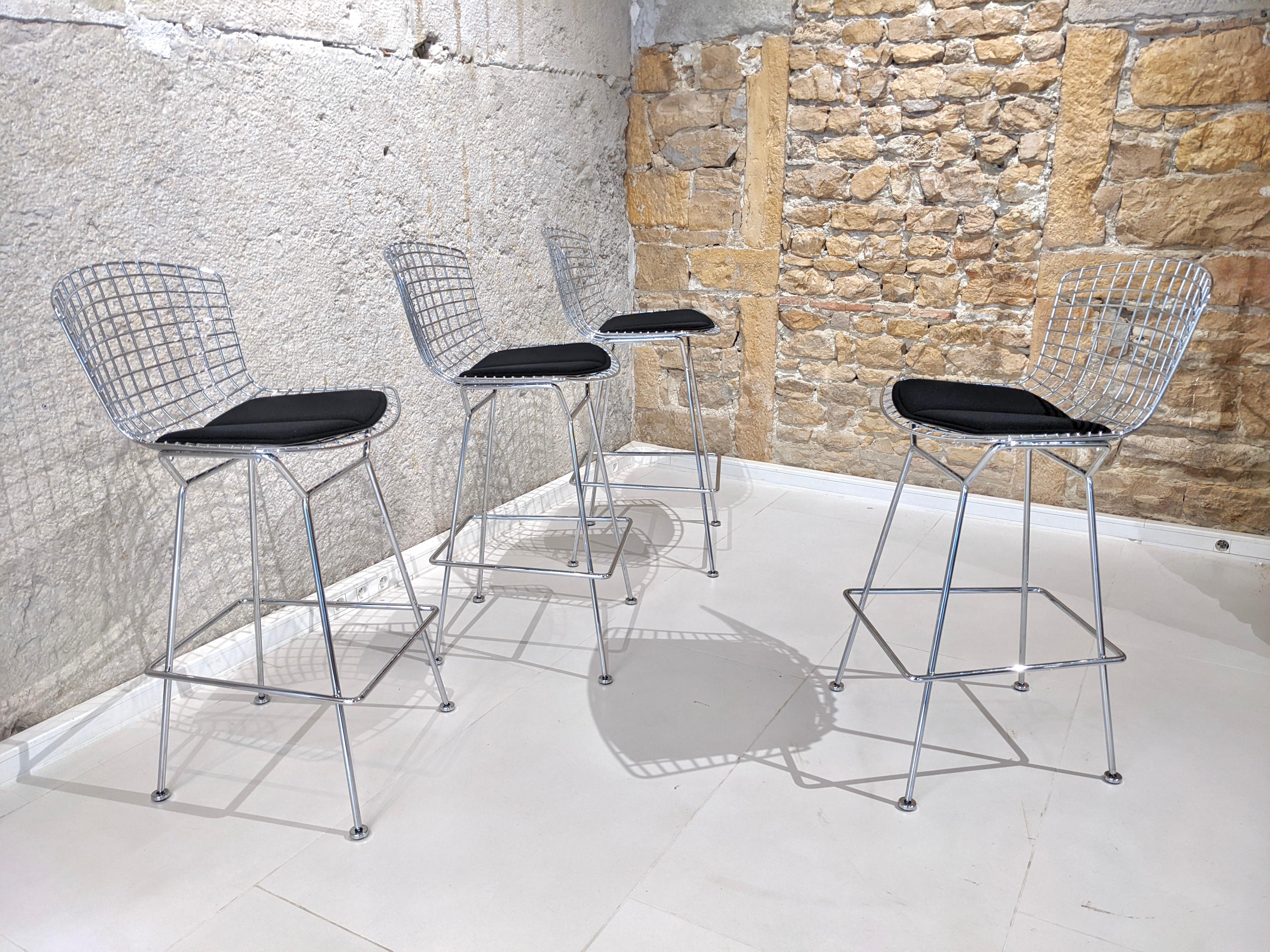 Set of 4 Harry Bertoia bar stools for Knoll. 

Perfect condition (as new). Chromed steel frame and black cushion signed KNOLL at the back. 
The bar stools are also signed. (see picture)

Measures: - W 52 cm x L 48cm H 105 cm.