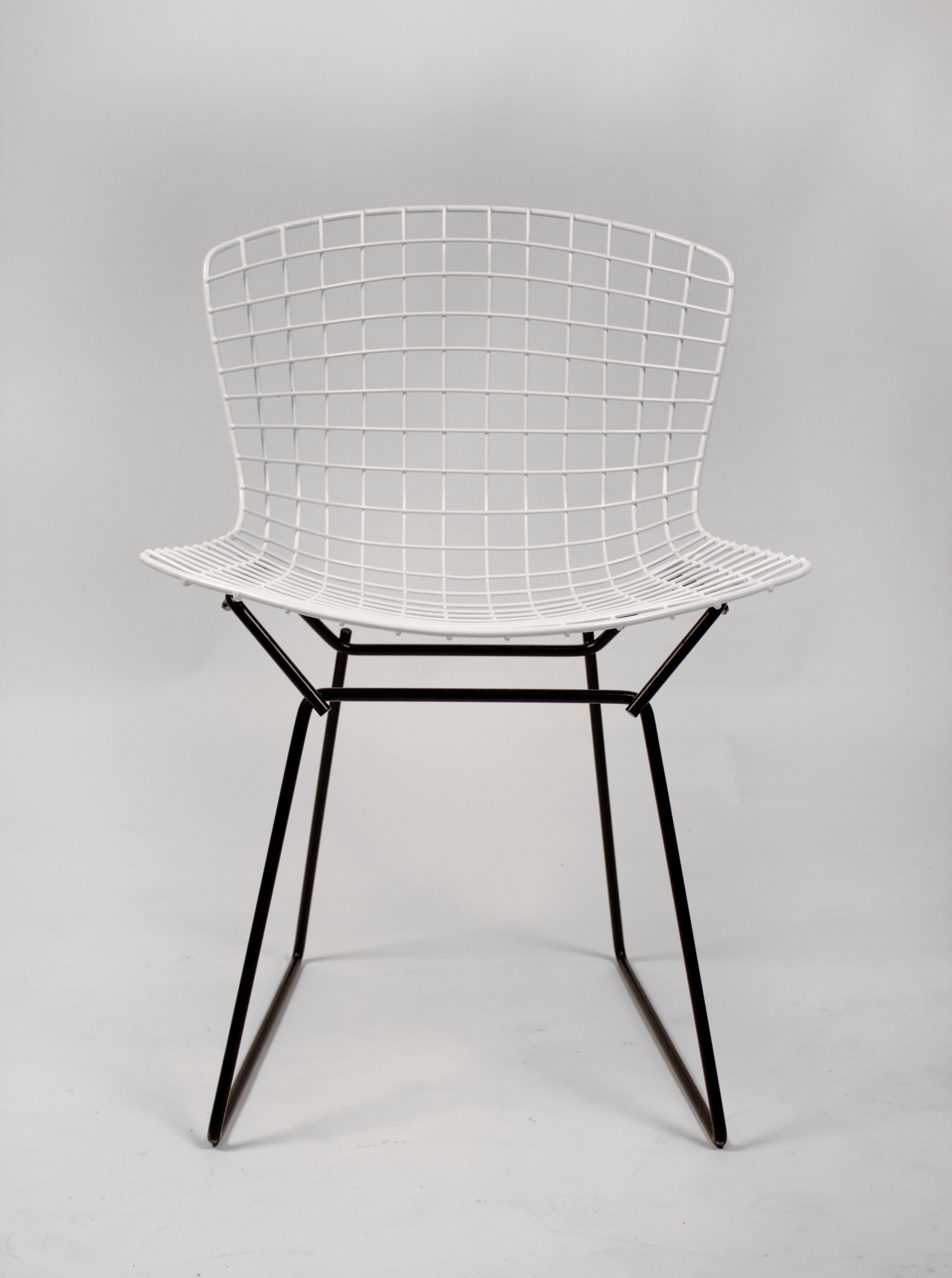 A set of four vintage Harry Bertoia for Knoll side chairs freshly sandblasted and professionally powder coated back to the original black and white finish. This is the best color combination in our opinion. Suitable for indoor or outdoor use.