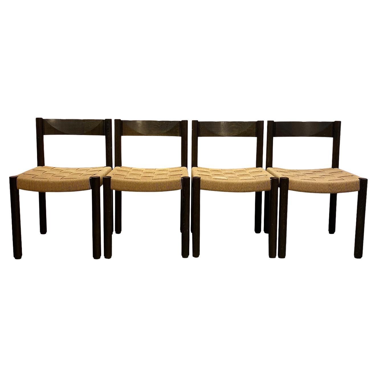 Set of 4 wooden chairs,  Circa 1960. 
Designed by Swiss designer Robert Haussmann  for Dietiker. 

Structure in stained oak, seat in hand-woven rope. Good condition. 

