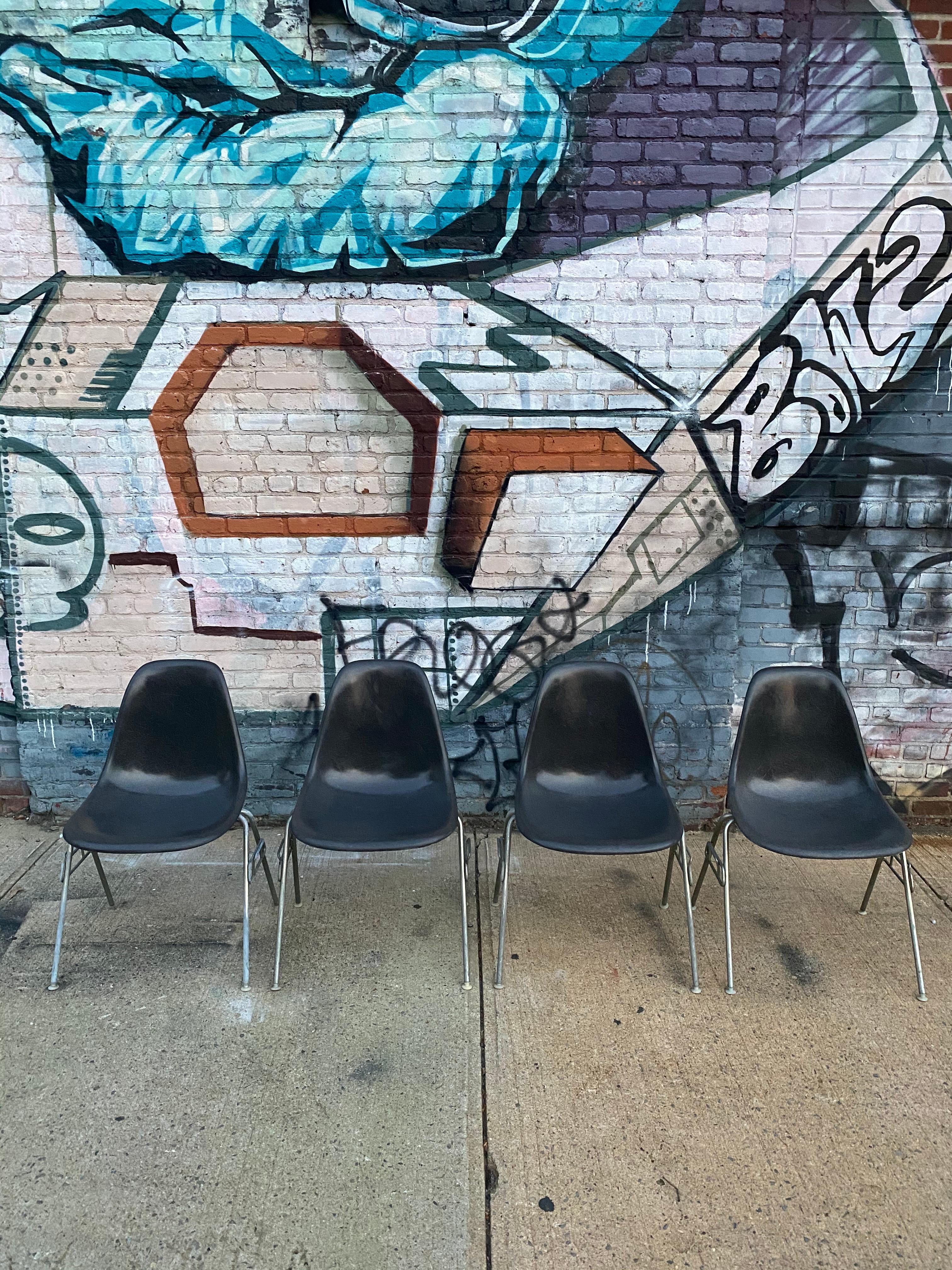Beautiful set of 4 Herman Miller Eames fiberglass dining chairs. On vintage Herman Miller stacking base. Elephant grey is one of the best colors for this chair. All chairs signed and guaranteed authentic. Rubber shock mounts re adhered for