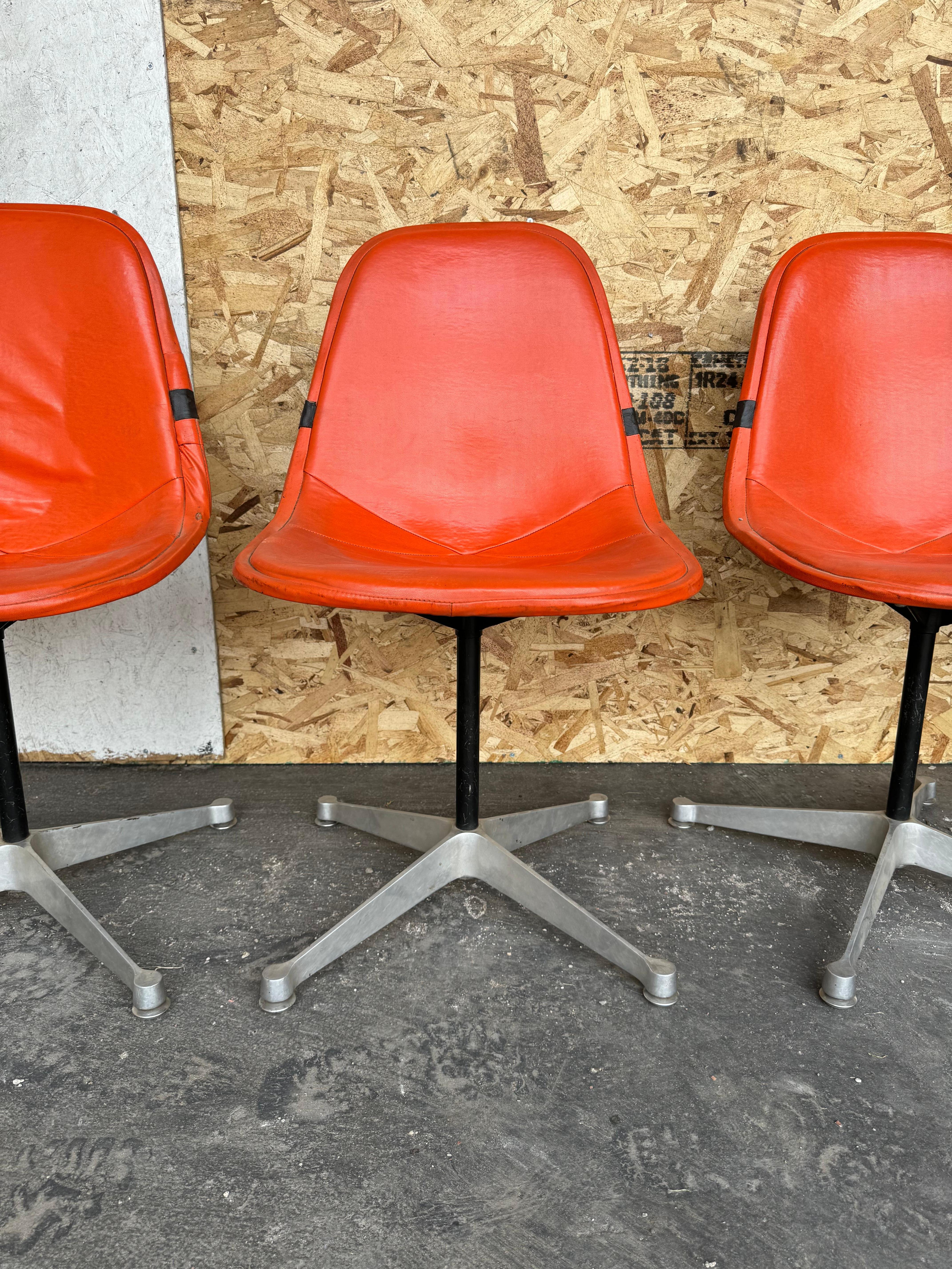 Set of 4 Early Production  Herman Miller designed by Charles Eames.. Orange Pad Swivel PKC1 aluminum base Dining Chairs.Nice original condition, minor blemishes to naugahyde (see photo) Classic Mid Century Modern Design.. perfect for dinette ,