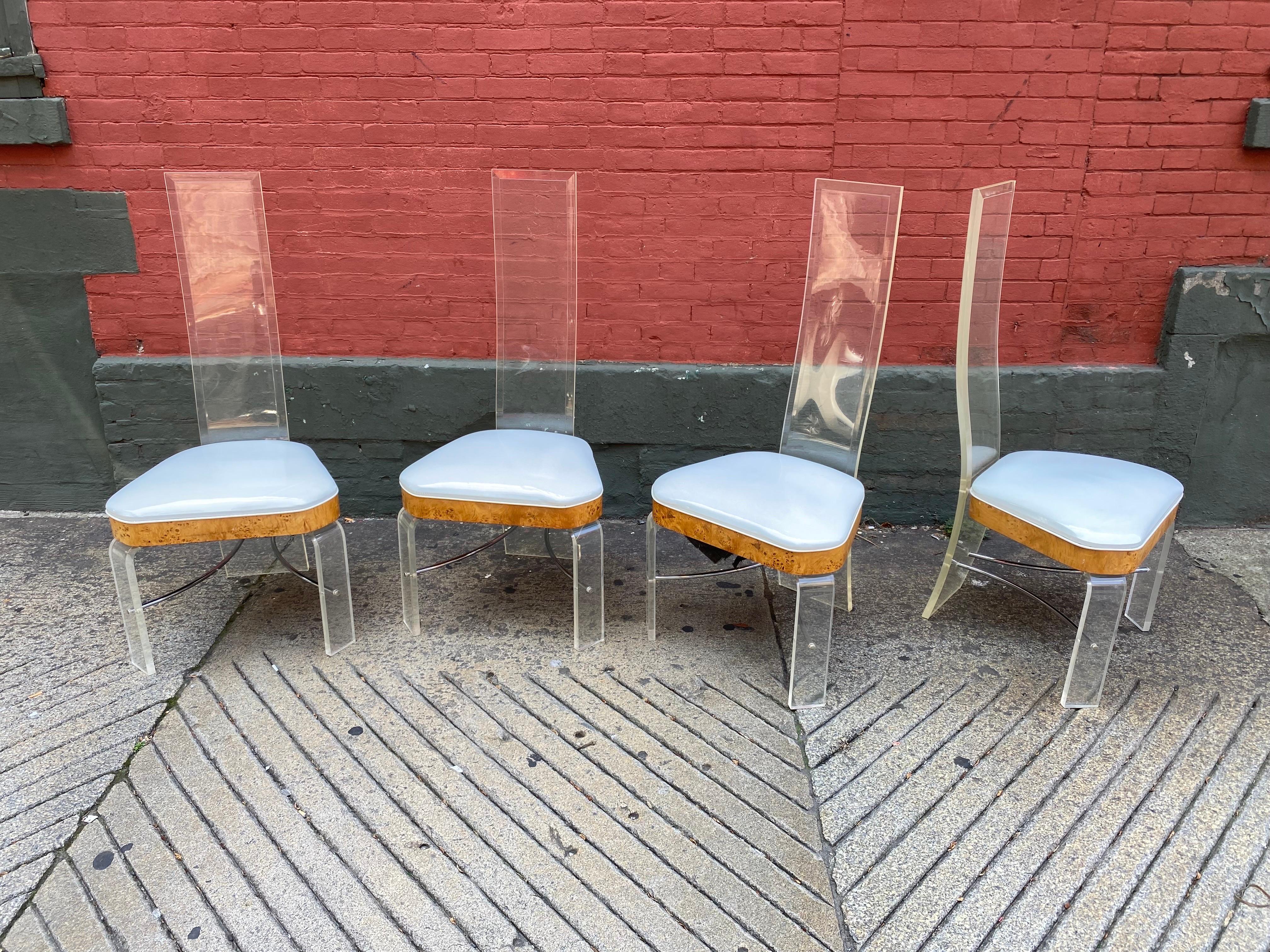 Set of 4 Hill Manufacturing Tall Back Lucite Dining Chairs.  Chairs have a burl wood band around seat cushion.  Original Patent Leather White Seats are very clean!  Chairs are sturdy and very clean examples!  Dramatic Chairs that would add a lot to