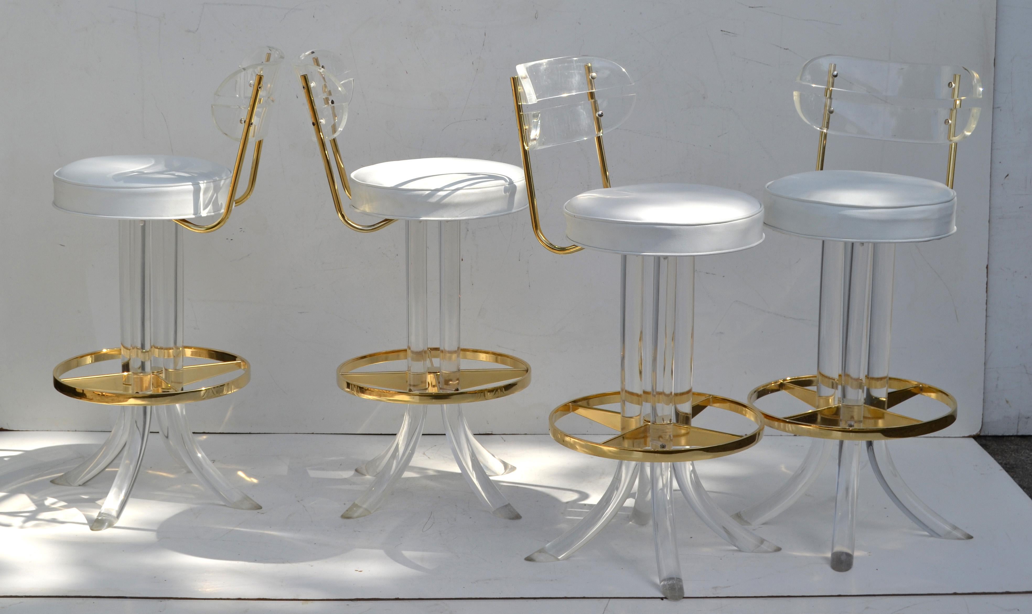 Exceptional Mid-Century Modern fantastic and rare set of four Lucite swivel bar stools with Gold plated Detail by Hill Manufacturers made in America in the 1970s.
Restored and Reupholstered and ready for a new Home.