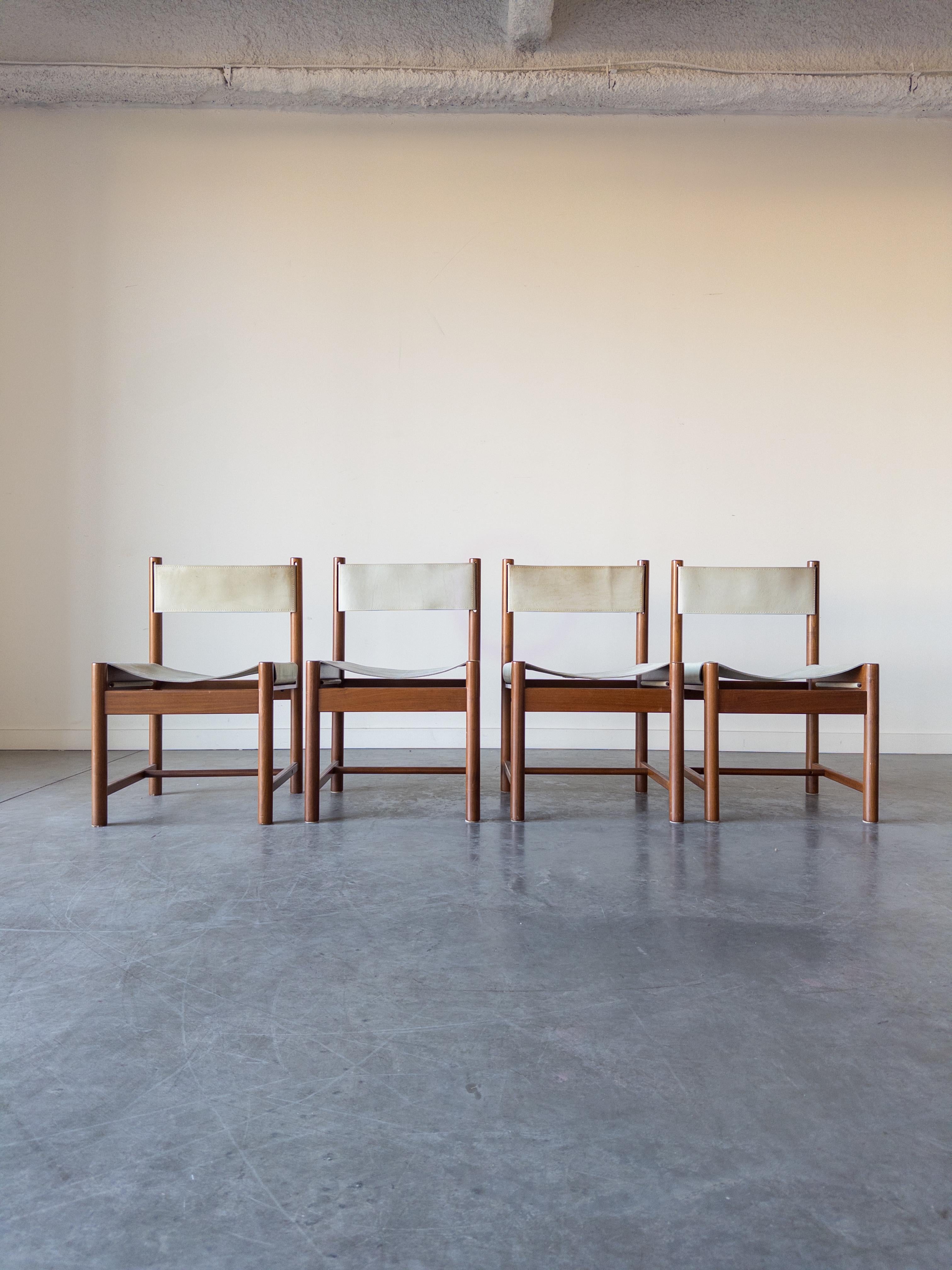 Sling chairs designed by Michel Arnoult for his Alagoas Collection and produced in Brazil by Forene S.A. Móveis do Nordeste. Featuring a solid frame made of rare Imbuia wood and thick saddle leather. Original production labels are intact.

