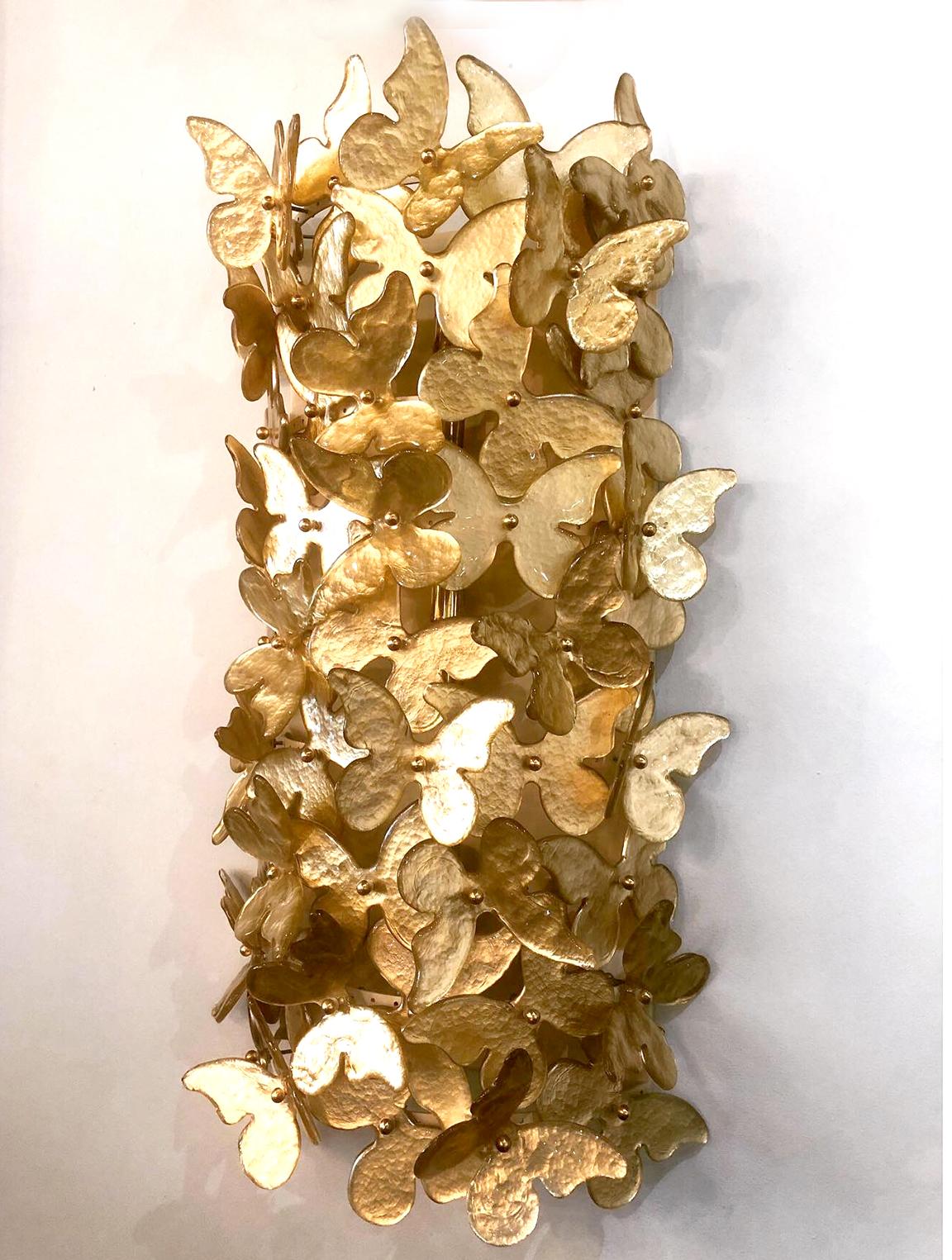 An extraordinary set of 4 Italian gold glass wall lights, attributed to Barovier & Toso, all hand blown butterflies, joined together on a brass backplate- can be sold as pairs.