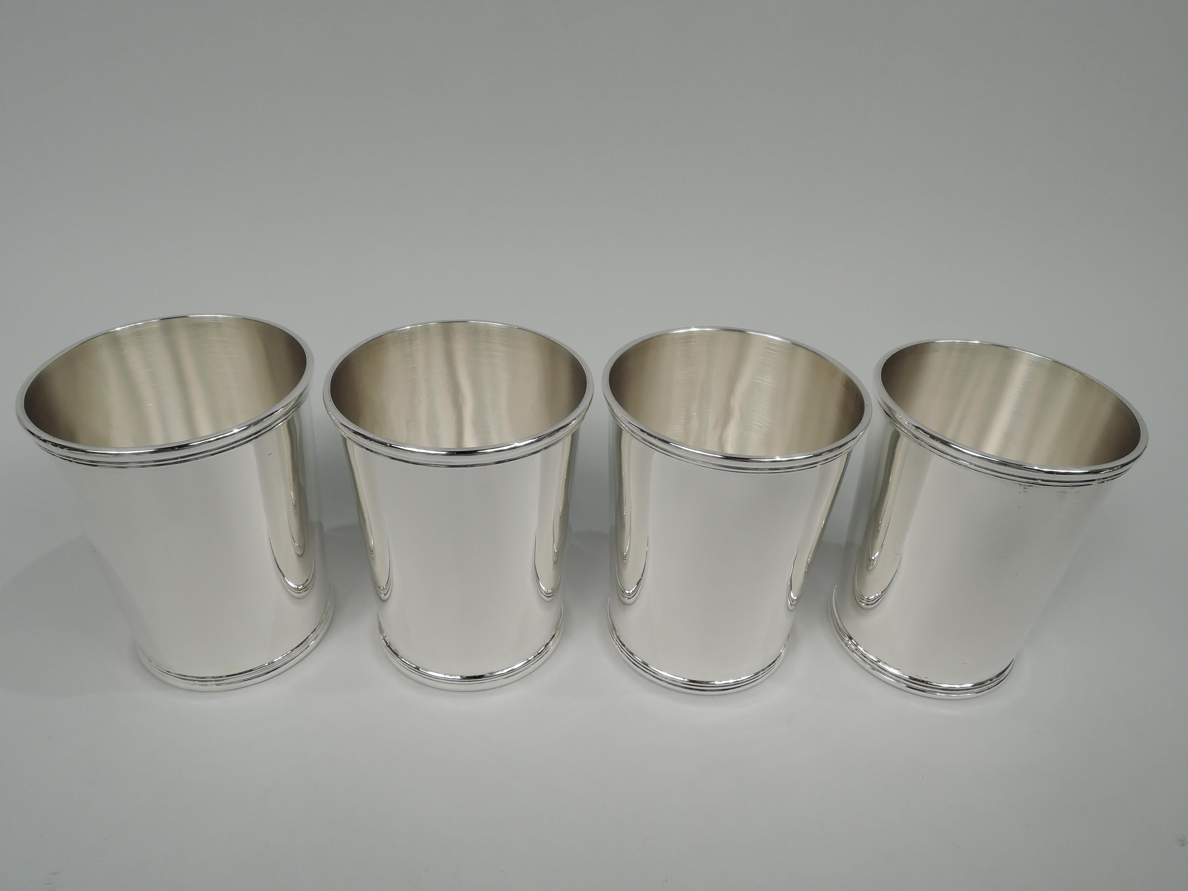 Set of 4 sterling silver mint julep cups. Made by International Silver Co. in Meriden, Conn. Each: Straight and tapering sides with reeded rim and base. Fully marked including maker’s stamp and no. C3532. Total weight: 13.3 troy ounces. 