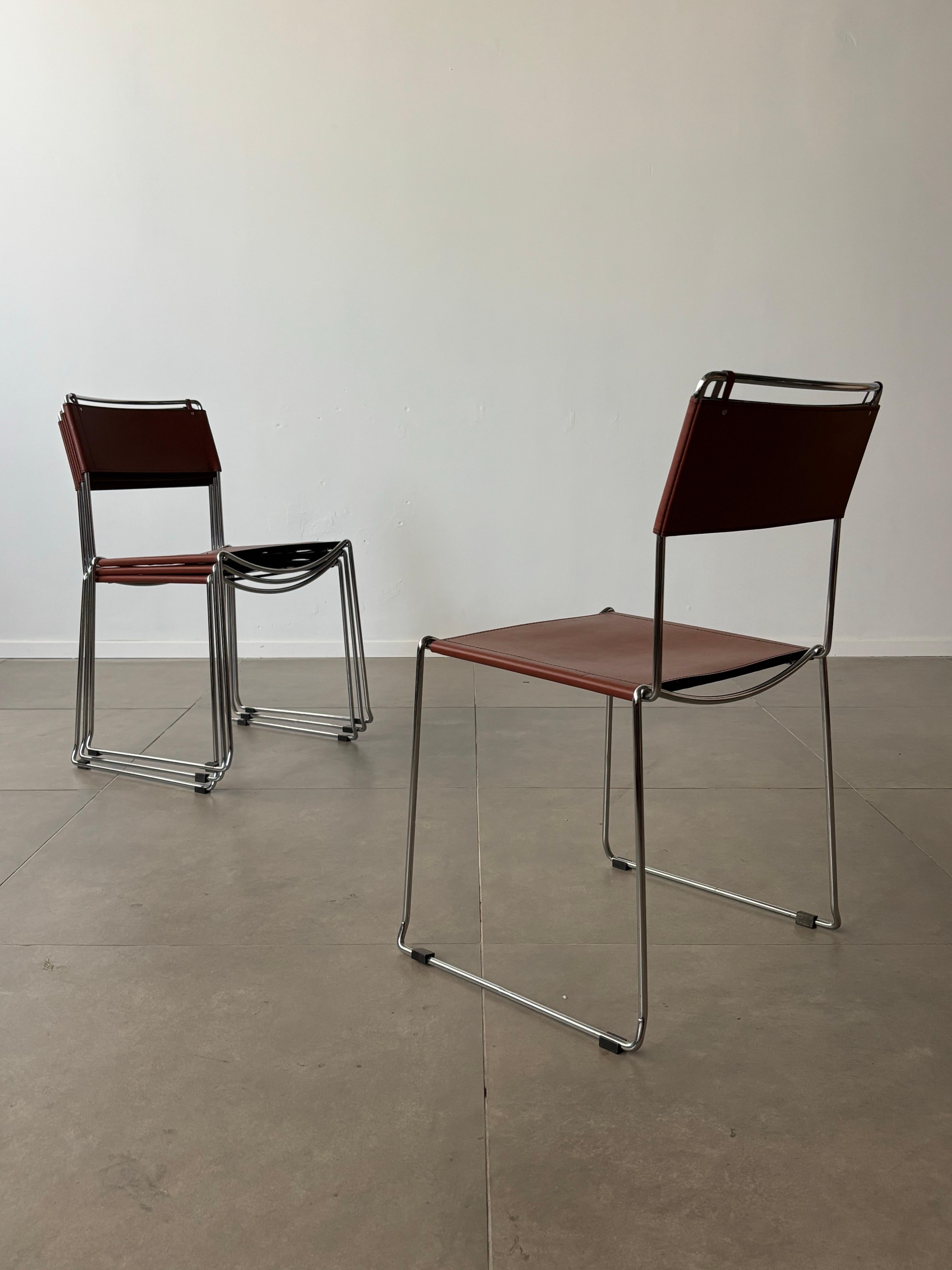 A set of four Italian chairs designed by Giandomenico Belotti in the 1980s, featuring a sleek combination of brown leather upholstery and a chrome-plated steel base. These chairs embody Belotti’s signature blend of minimalist aesthetics and