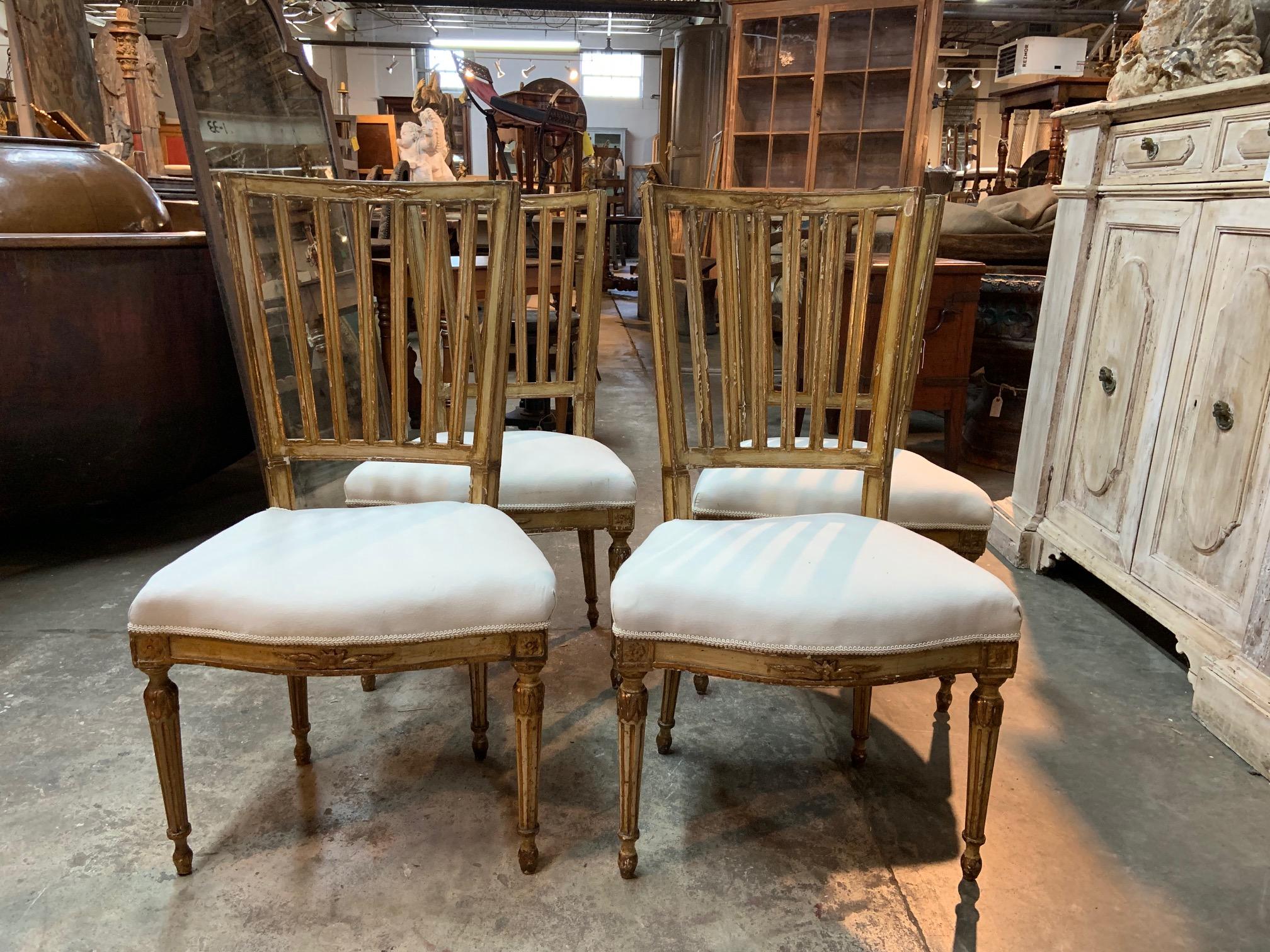 A wonderful Italian Louis XVI period set of four side chairs soundly constructed in polychromed and gilt wood. Original polychromed and gilt finish with sensational patina.