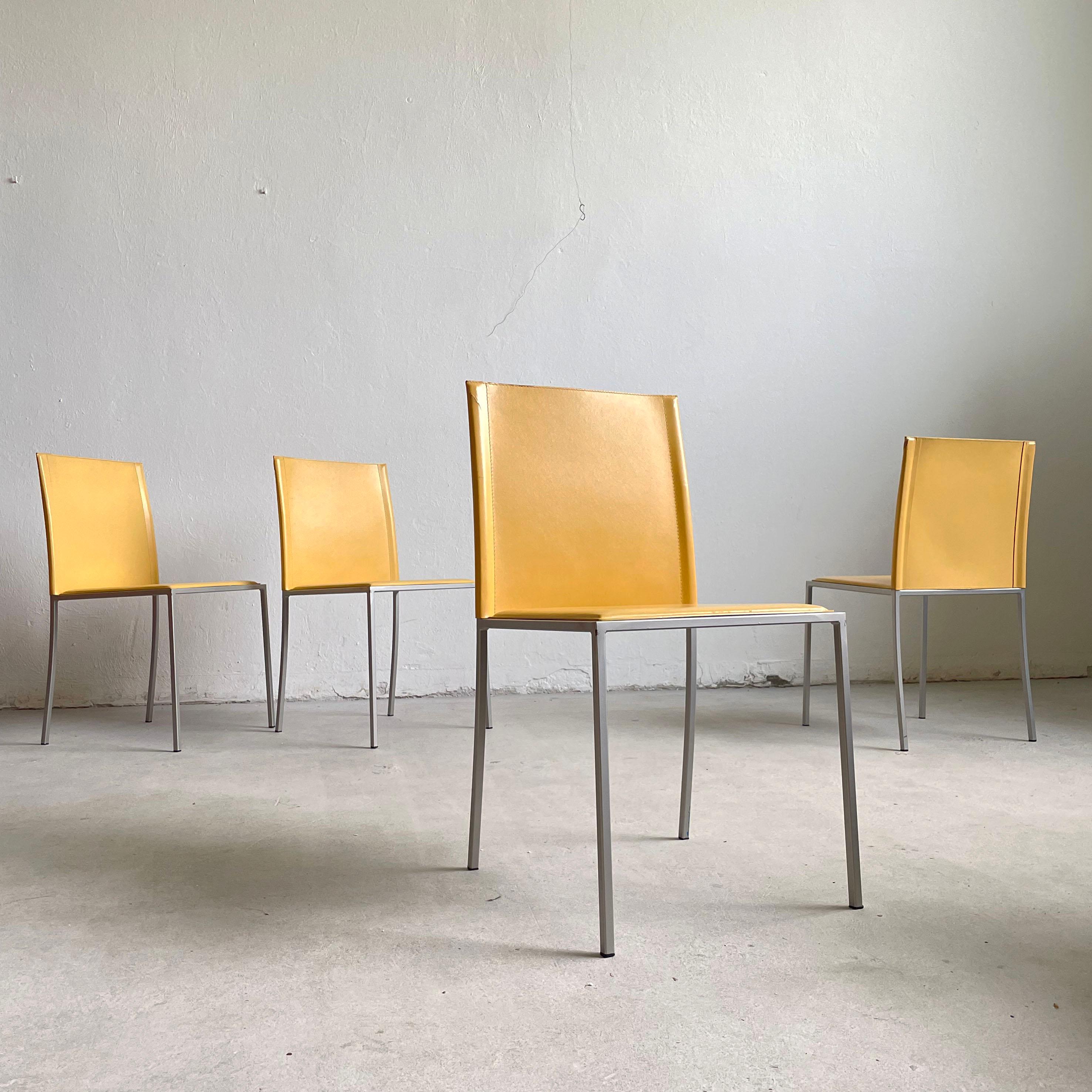 Set of 4 leather dining chairs produced in Italy in the 1990's by Calligaris

Elegant minimalist design. The chairs feature sturdy minimalist powder-coated metal frame and seats upholstered in high quality Italian leather in yellow color 

The