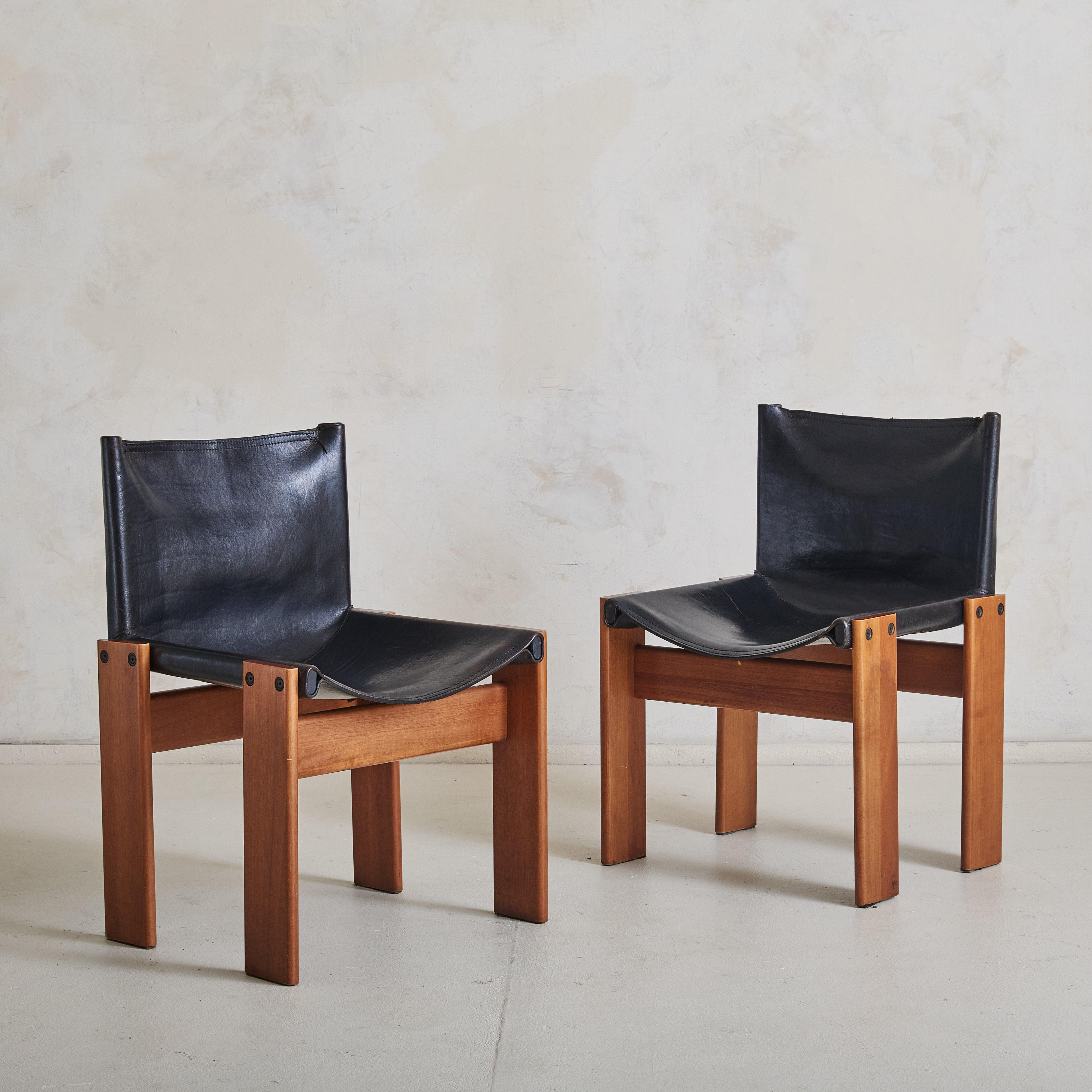 A set of four Italian 'Monk' dining chairs by Afra & Tobia Scarpa for Molteni. Designed in 1974, the Monk chair is one of many distinctive and highly regarded designs from the duo. Its humble form comprises solid walnut block legs with a black