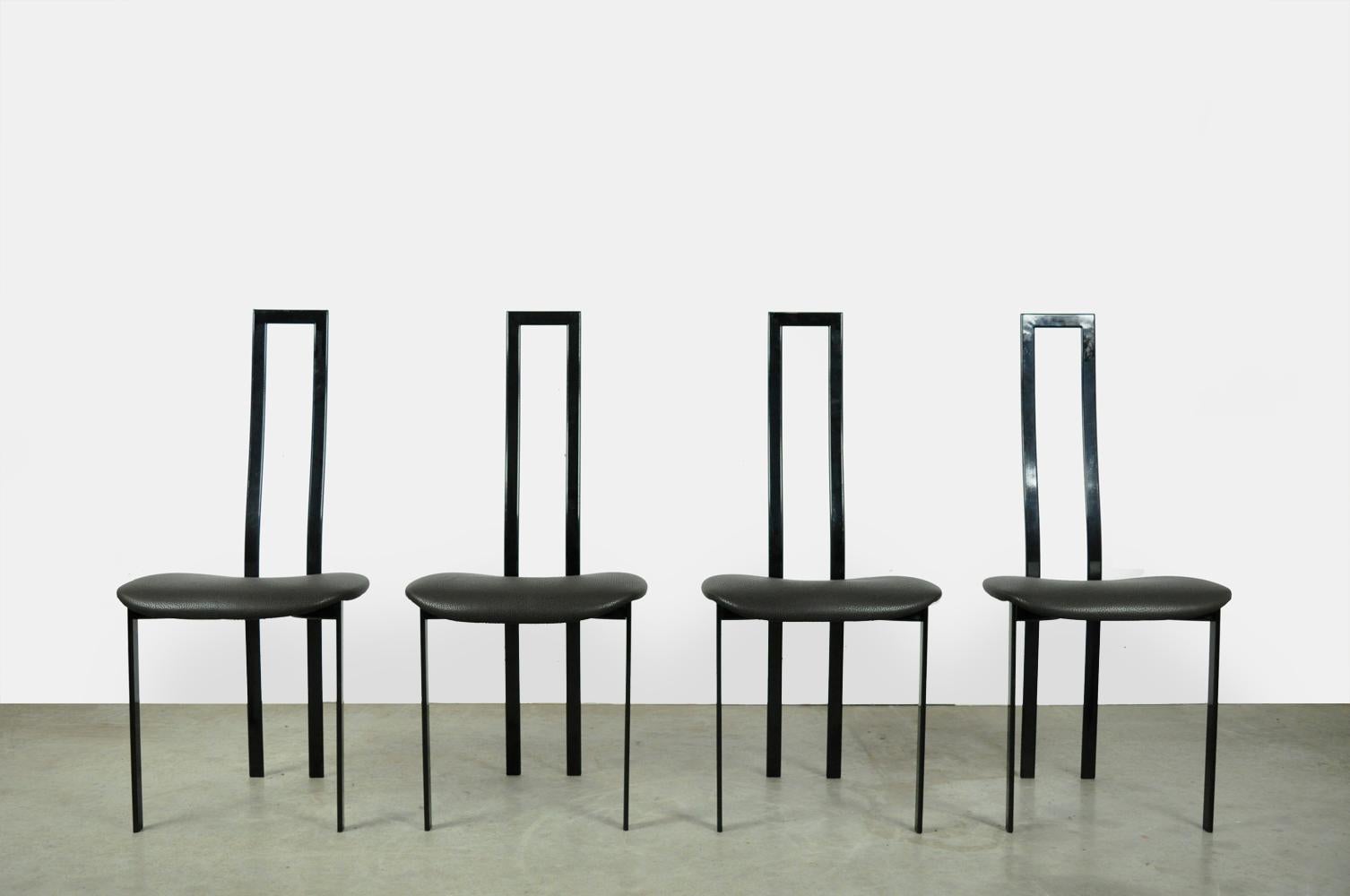 Set of 4 postmodern dining table chairs designed by the Italian artist Maurizio Cattelan, 1980s. The elegant chairs have a slim black metal frame and a fabric seat in mixed black-gray dots. The chairs are all marked.