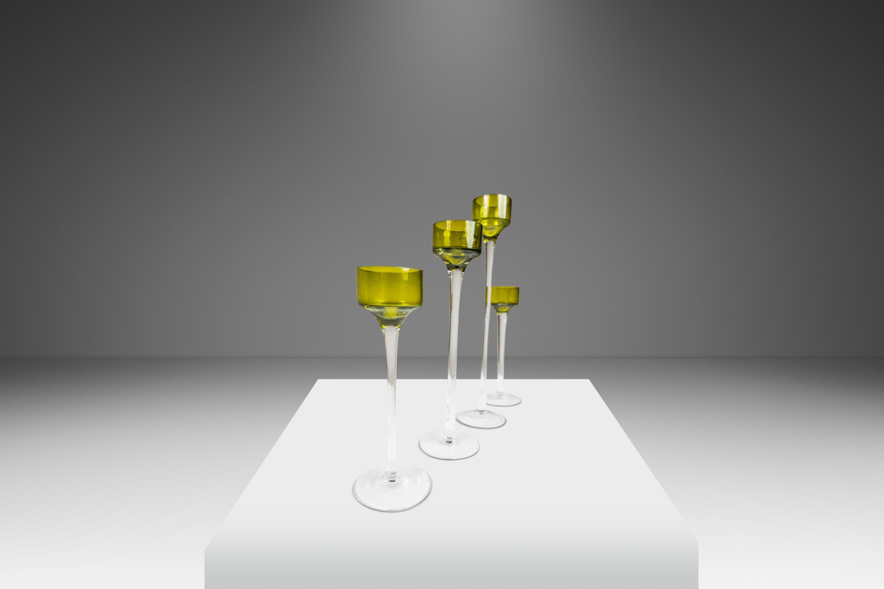  Introducing an artfully crafted set of four Italian Modern blown glass candlestick holders. Like snowflakes no two are alike and each is ever so slightly different in size and shape. With elegant elongated shapes these exquisite art pieces feature