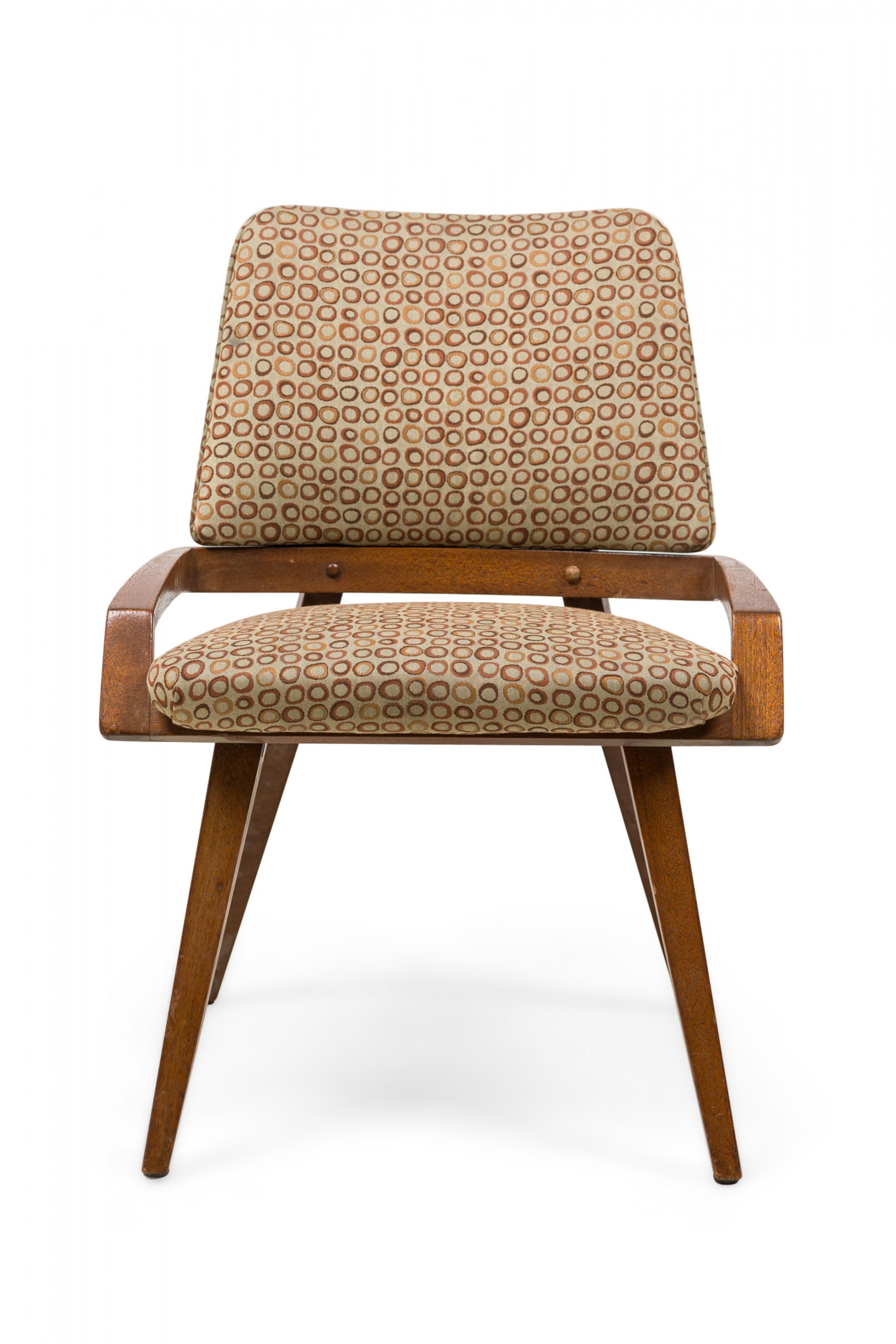 Set di 4 poltrone Mid-Century American Modern (anni '50) con braccioli bassi stilizzati, schienale e seduta rivestiti in tessuto a motivi circolari beige/taupe e poggianti su 4 gambe affusolate e strombate (John Keal) (PREZZO COME SET)

Una ha il