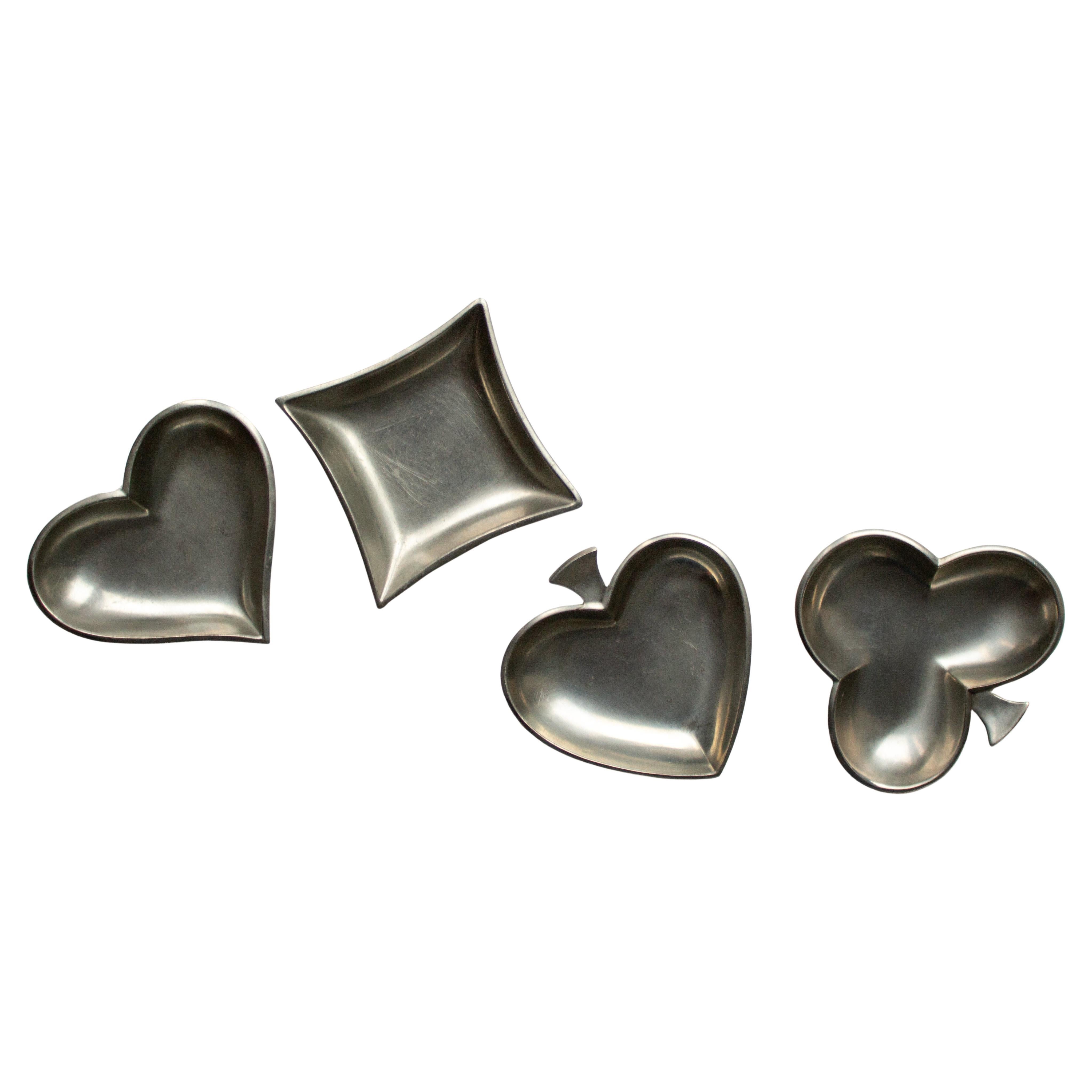Set of 4 Mid-Century Pewter Dishes in the Shape of Playing Card Symbols by Just Andersen, Denmark
Stamped Just, Denmark, 2630, 2631, 2632, 2633

Just Andersen’s pewter pieces are highly sought after on the antique market. His works are considered