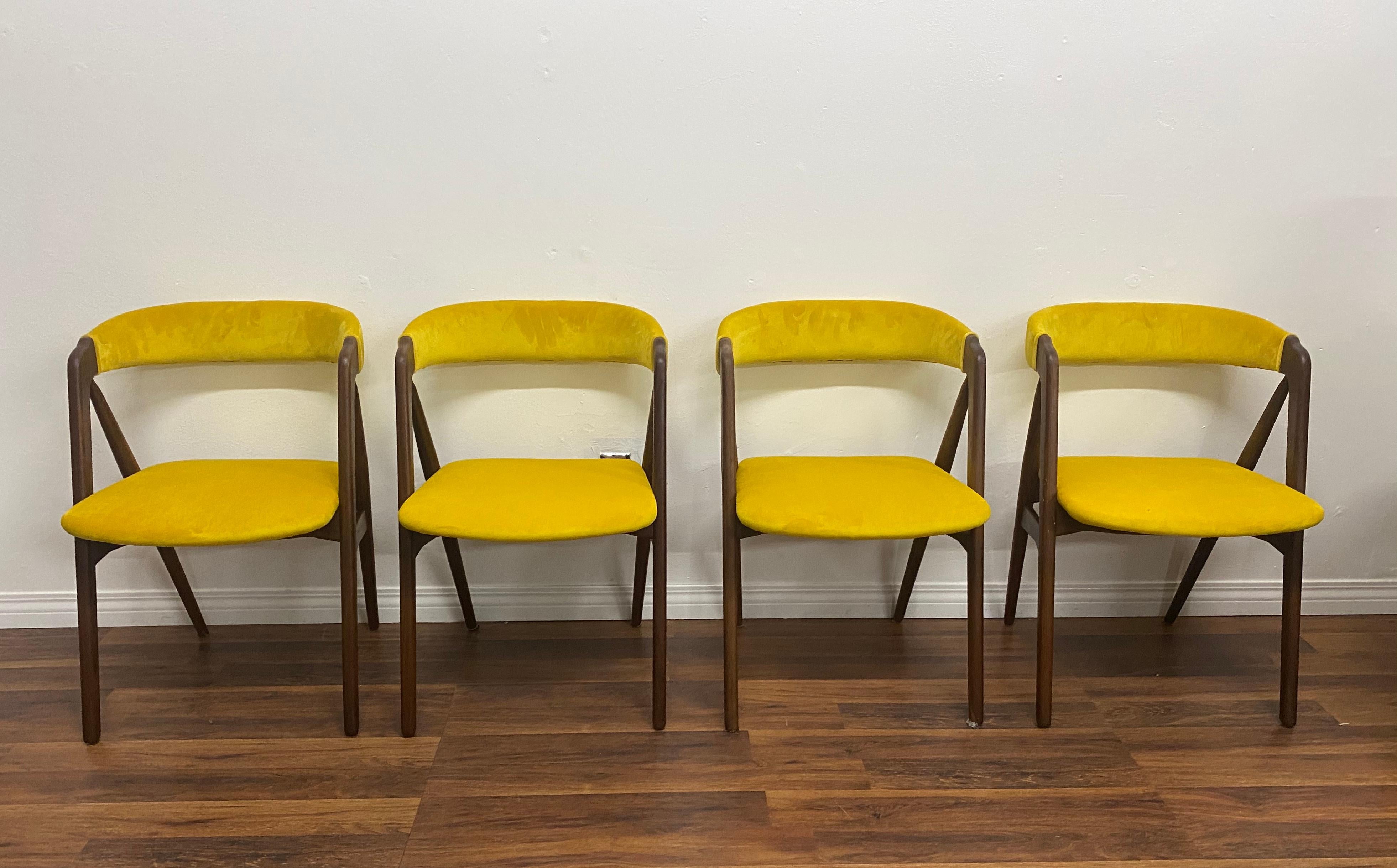 Set of 4 teak dining chairs by Kai Kristiansen, newly reupholstered in yellow velvet.