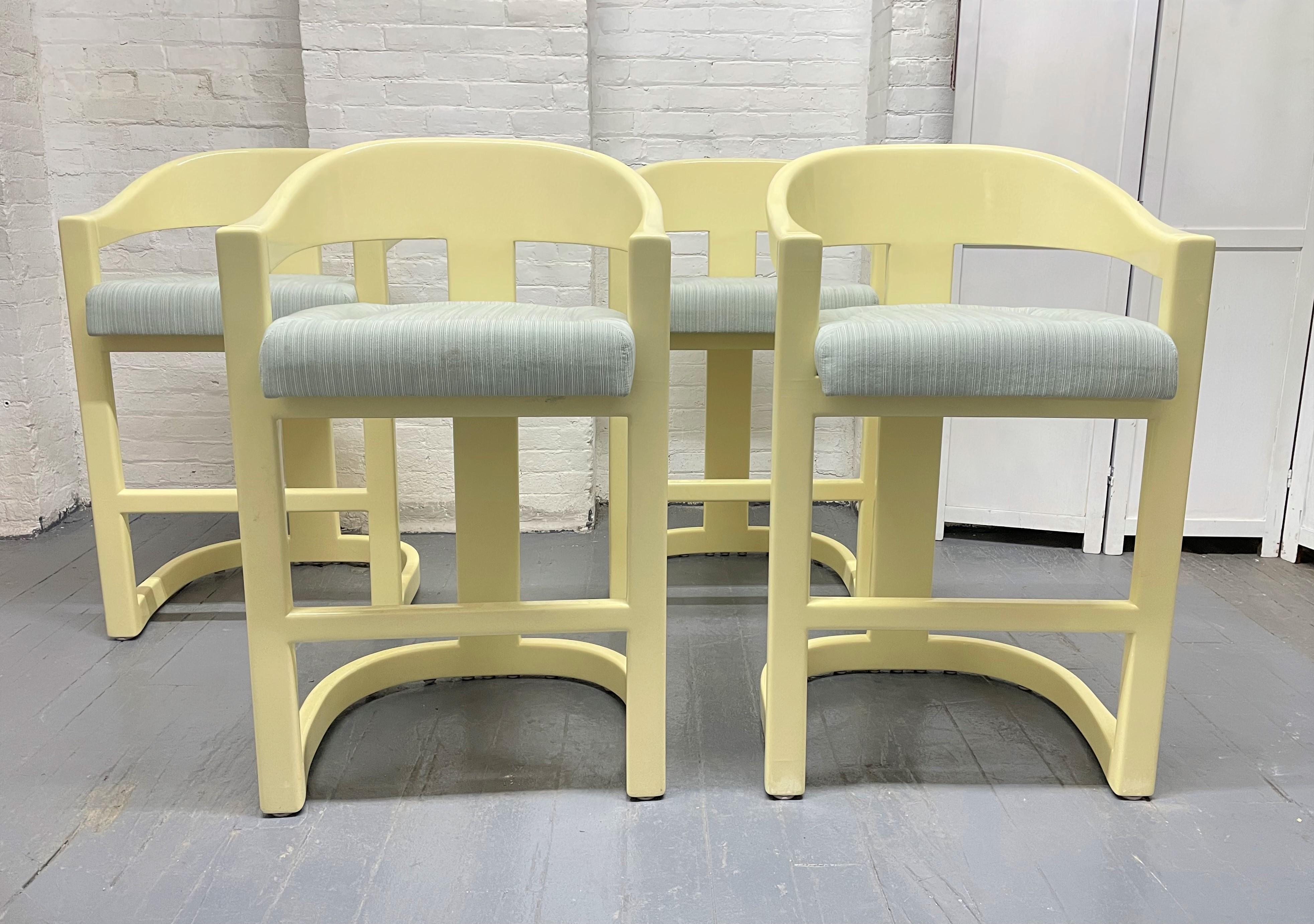 Set of 4 Karl Springer Onassis bar stools. The stools' frame is lacquered wood with fabric covered cushioned seats. The stools have a nice, lacquered finish.