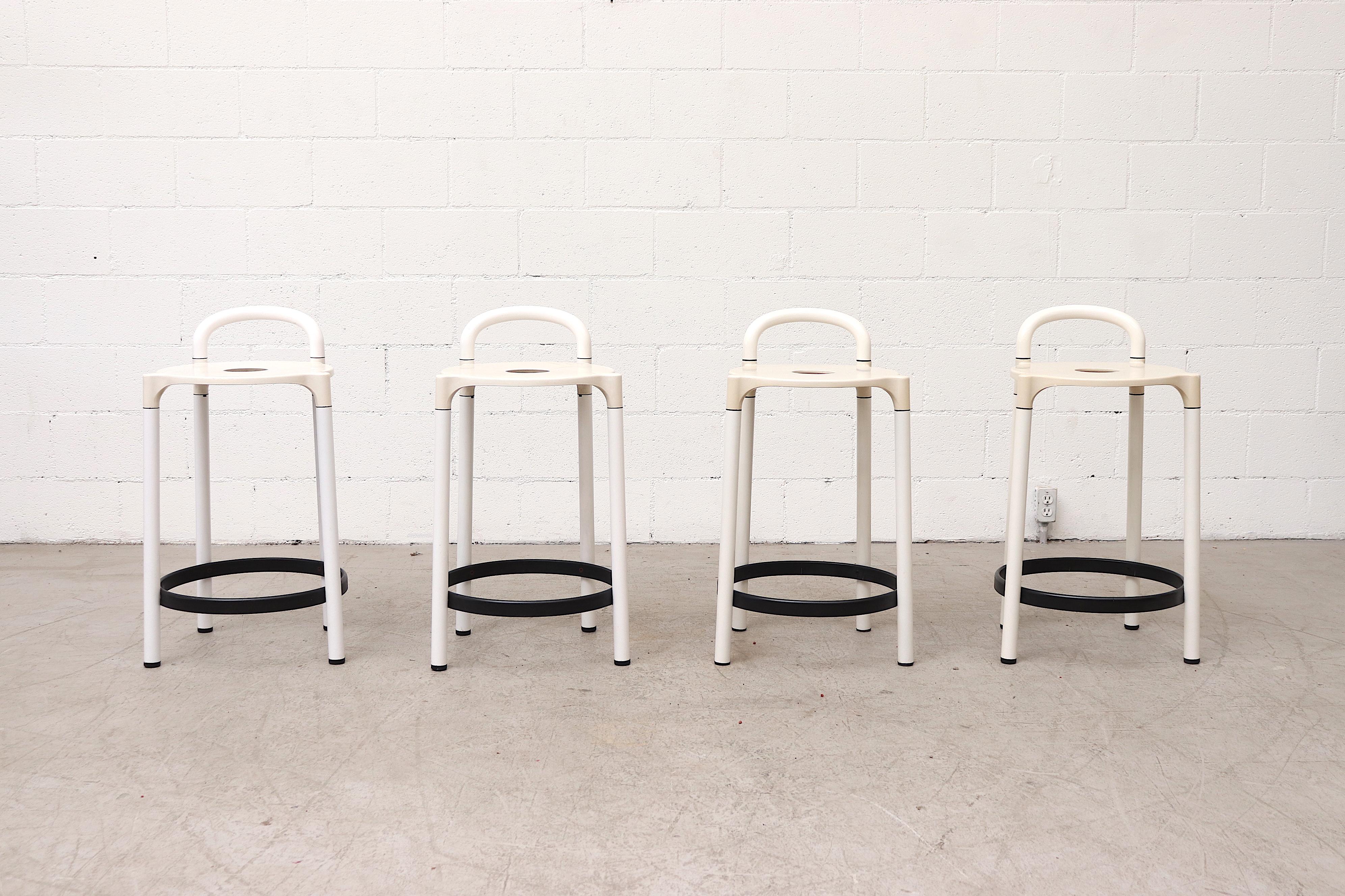 Awesome set of 4 midcentury Italian Kartell bar stools by Anna Castelli Ferrieri, 1979. White acrylic frame with black foot rests great modern design. Stools have visible wear and scratching, and are in very original condition. Wear is consistent