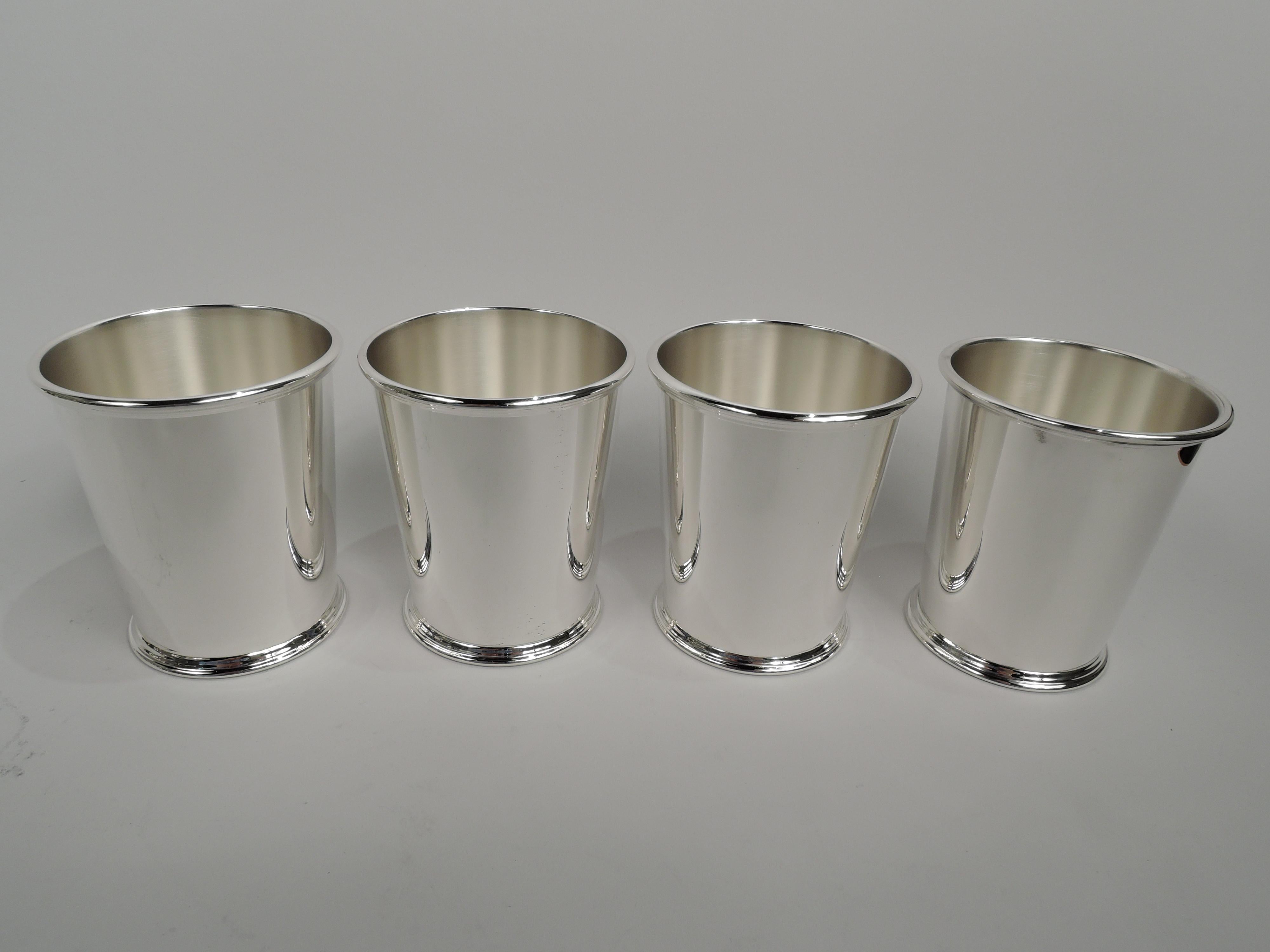Four sterling silver mint julep cups. Made by S. Kirk & Son in Baltimore. Each: Straight and tapering sides, reeded rim, and skirted foot. A great starter set for a housewarming or wedding. Fully marked including maker’s stamp (1932-61) and no. 277.