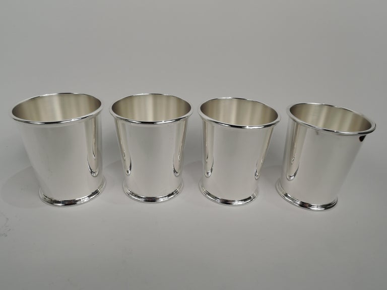 Four sterling silver mint julep cups. Made by S. Kirk & Son in Baltimore. Each: Straight and tapering sides, reeded rim, and skirted foot. A great starter set for a housewarming or wedding. Fully marked including maker’s stamp (1932-61) and no. 277.