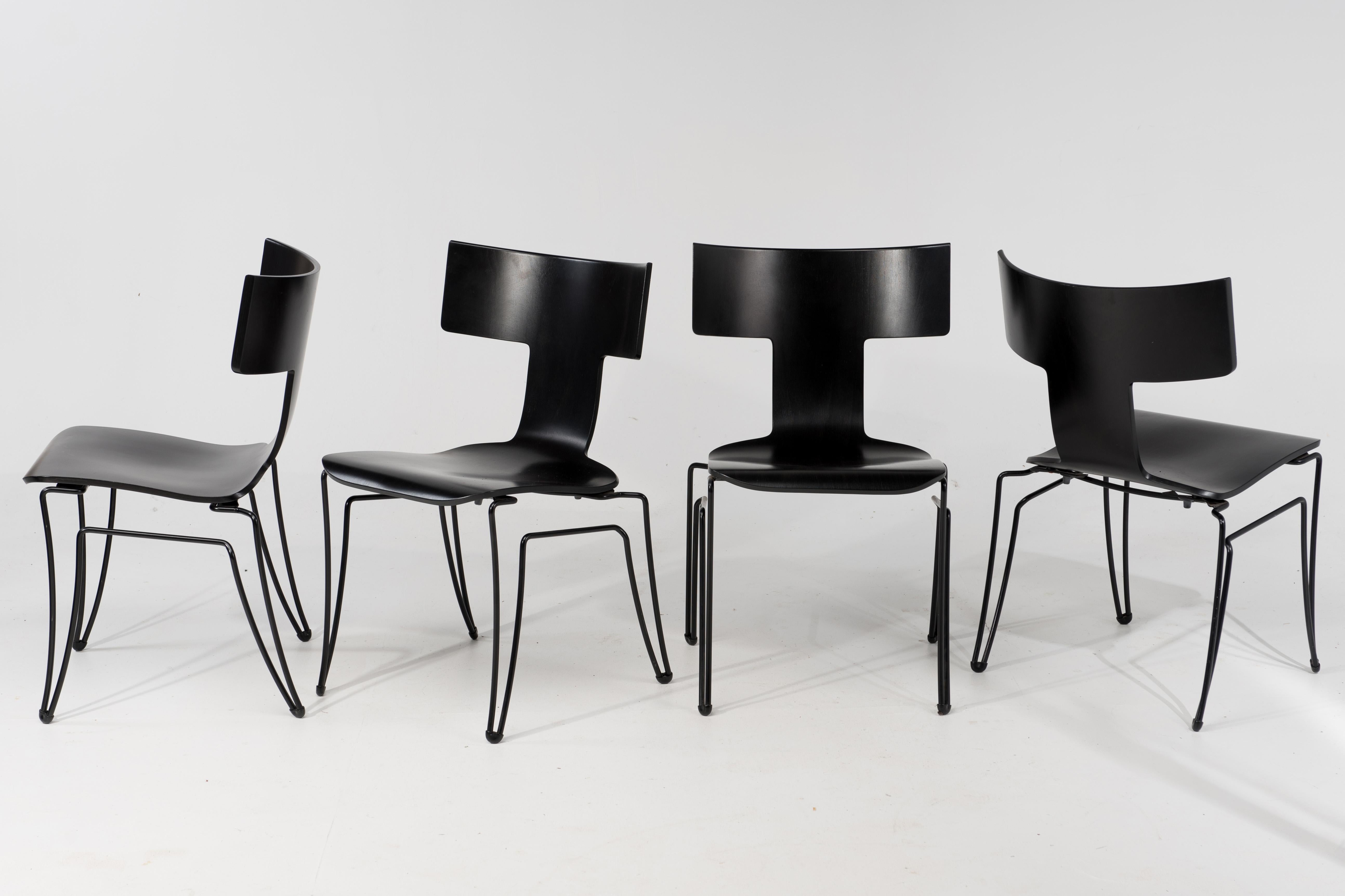 Set of 4 iconic klismos style Anziano chairs produced by Donghia in the 1980s and designed by John Hutton, having black coated steel wire structure and molded beechwood veneer. Chairs are stackable. Finish is not solid or opaque but subtly shows the