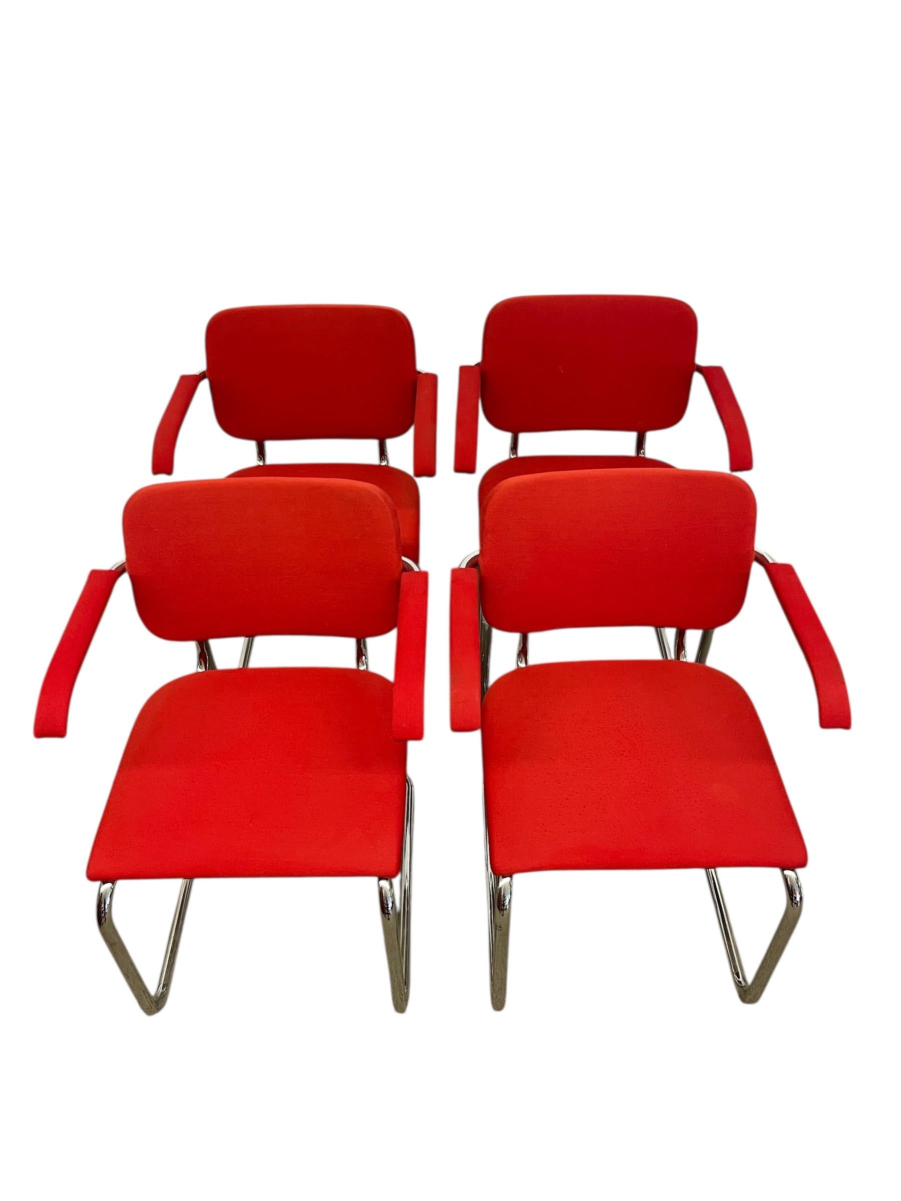  Set of four authentic Knoll Cesca armchairs, a celebrated design blending Bauhaus-inspired form with modern comfort. These chairs feature the iconic cantilevered chrome-plated tubular frame, a hallmark of the Cesca style, paired with vibrant red