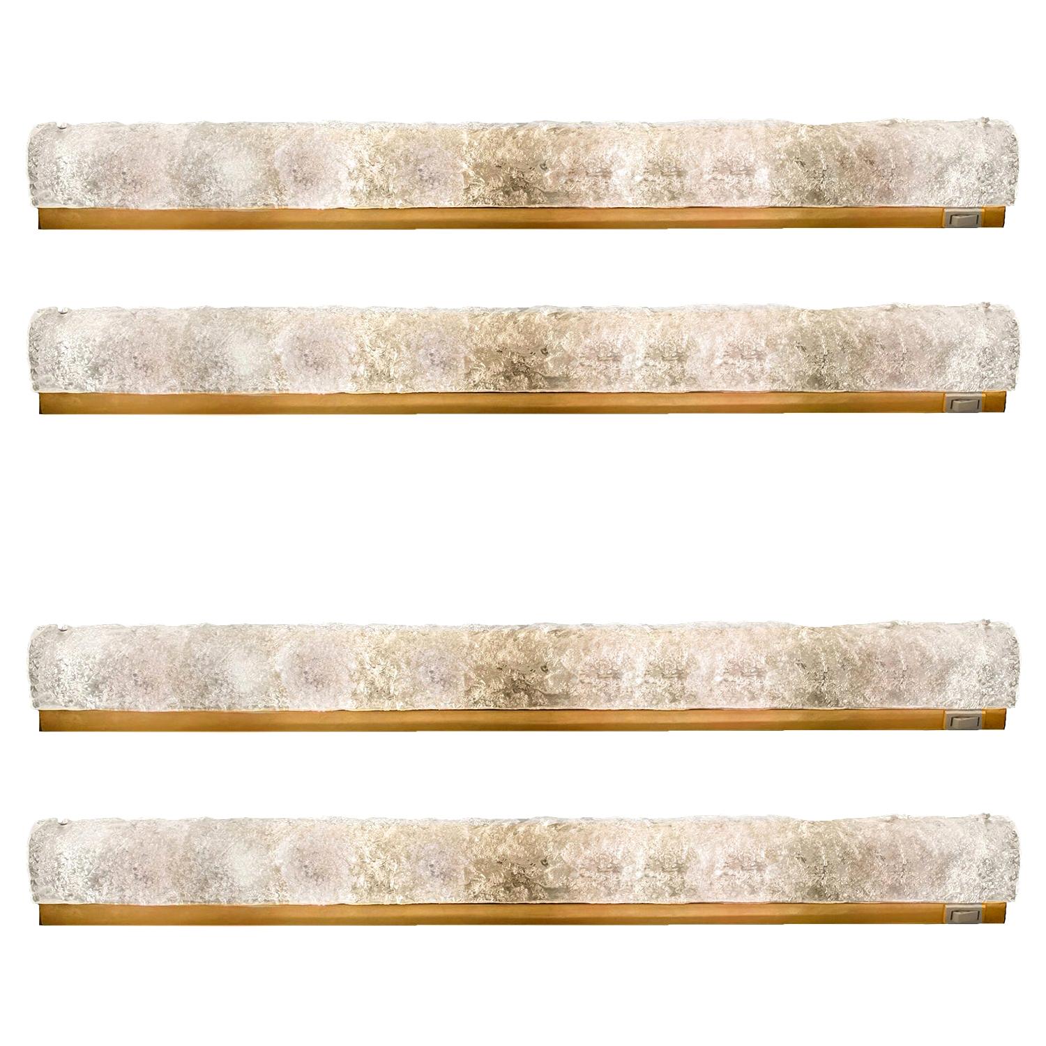Set of 4 large high-end Murano glass on a brass base sconces by Hillebrand, Germany, circa 1960s.
It consists of textured quality clear crystal tubular shade simulating ice on a brass frame.

The design allows this light to be placed either