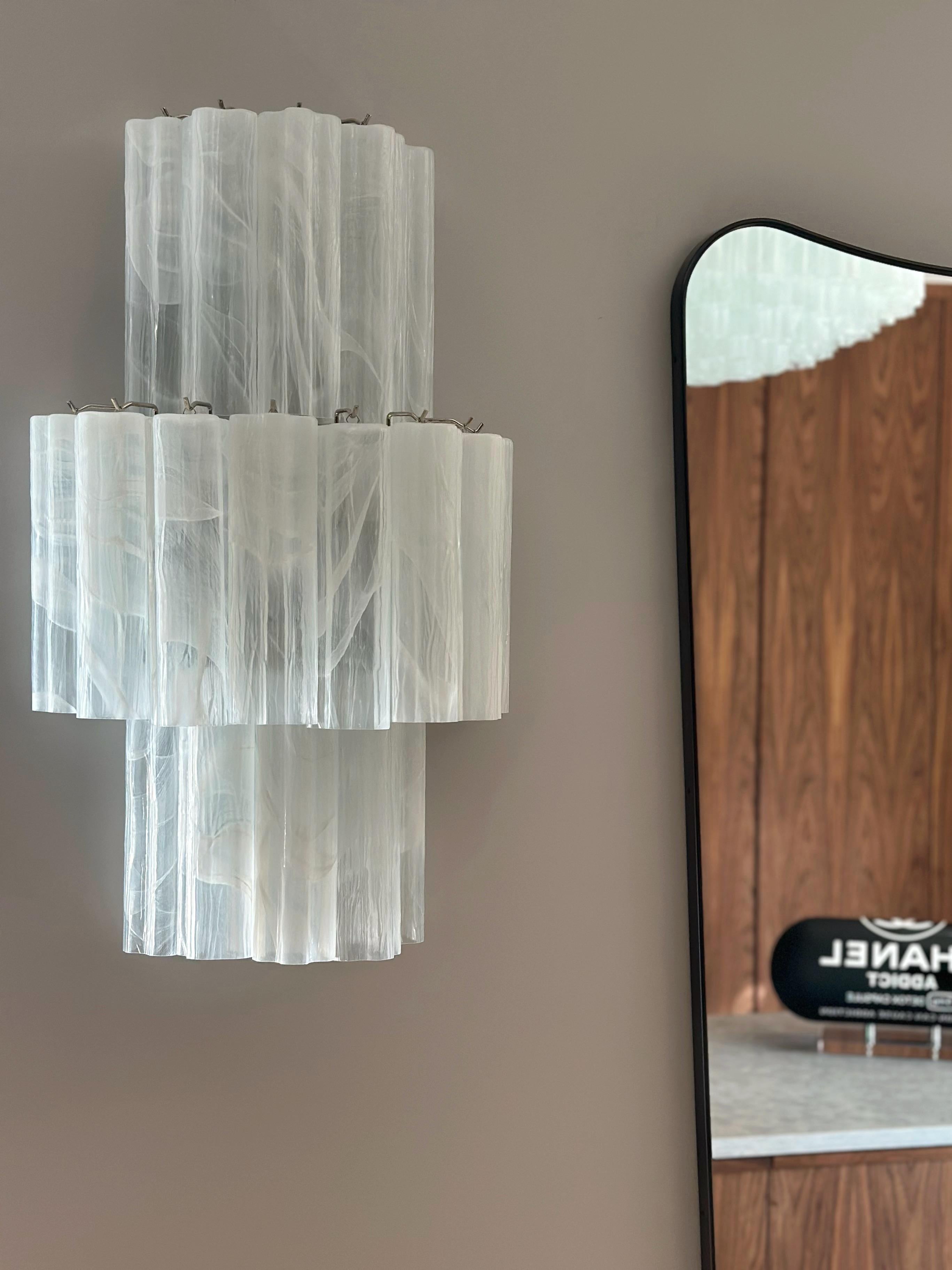Set of four (4) Large Bold Murano Wall Lamps in Swirled White Colored Glass. Each sconce consists of eighteen tubular prisms with finishes and fittings in chrome. Glass from the Italian Murano District. 
Traditional Italian Mid-Century Style,