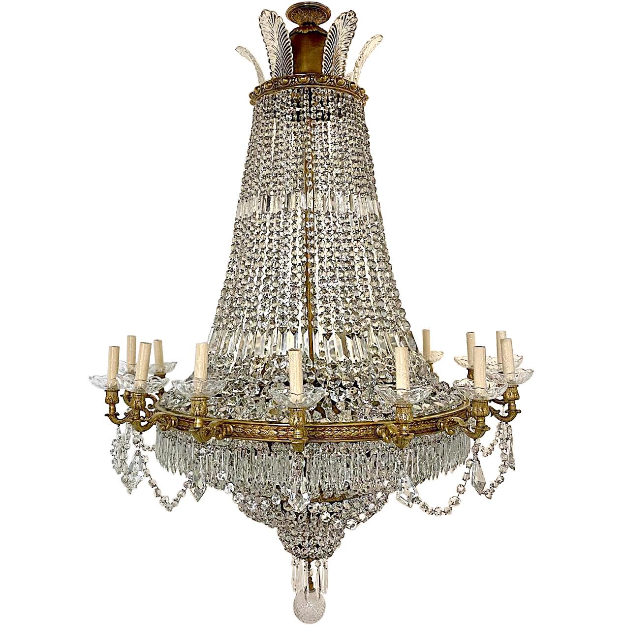 A set of four large French circa 1940s sixteen-arm chandelier with fourteen interior lights, original gilt body dressed with crystal chains and swags. Sold individually.

Measurements
Minimum drop 65
