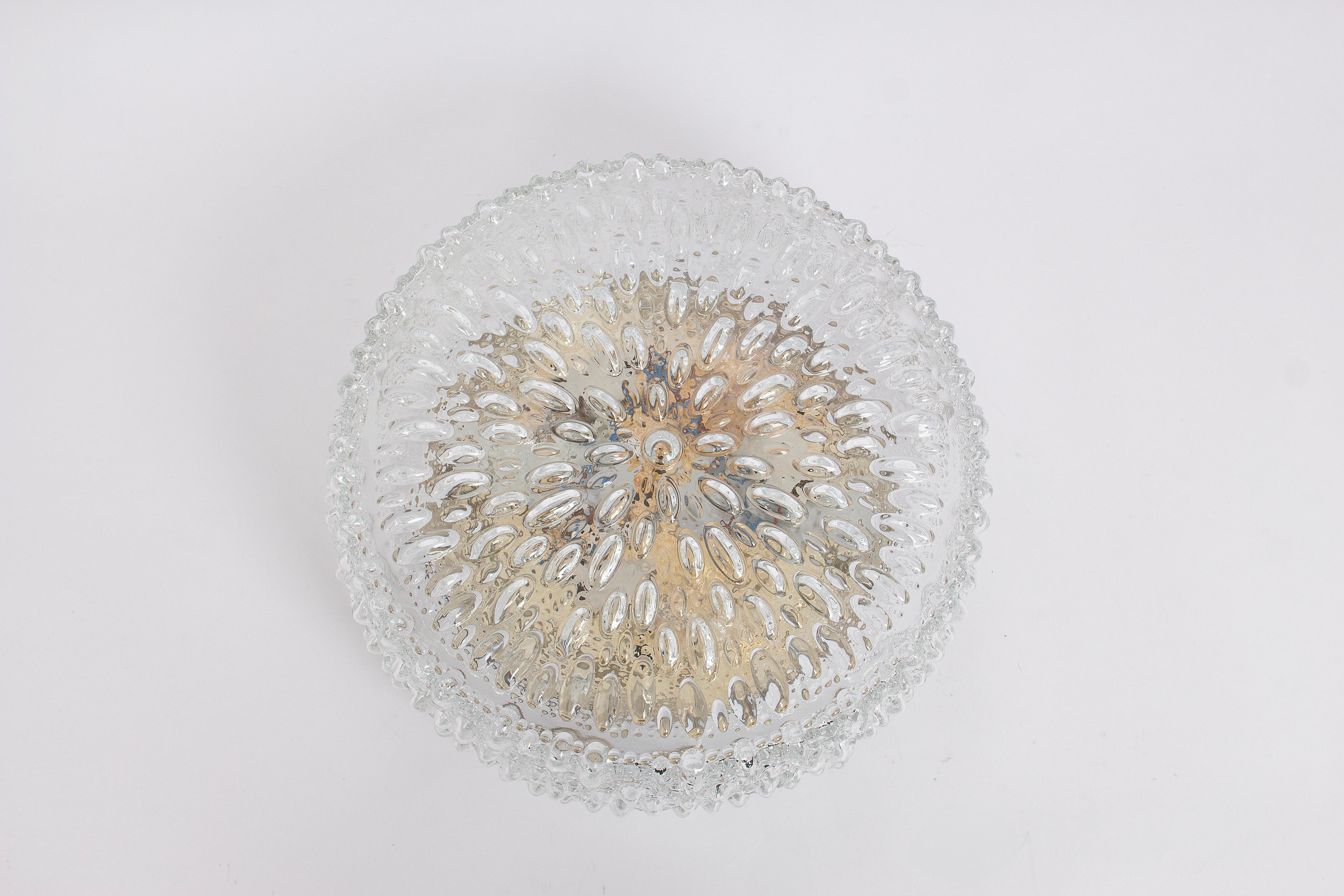 Set of 4 wonderful flush mount by Limburg, Germany, 1970s.
Special glass form on a metal base.

High quality and in very good condition. Cleaned, well-wired and ready to use. 

Each fixture requires 3x E27 standard bulbs.
Light bulbs are not