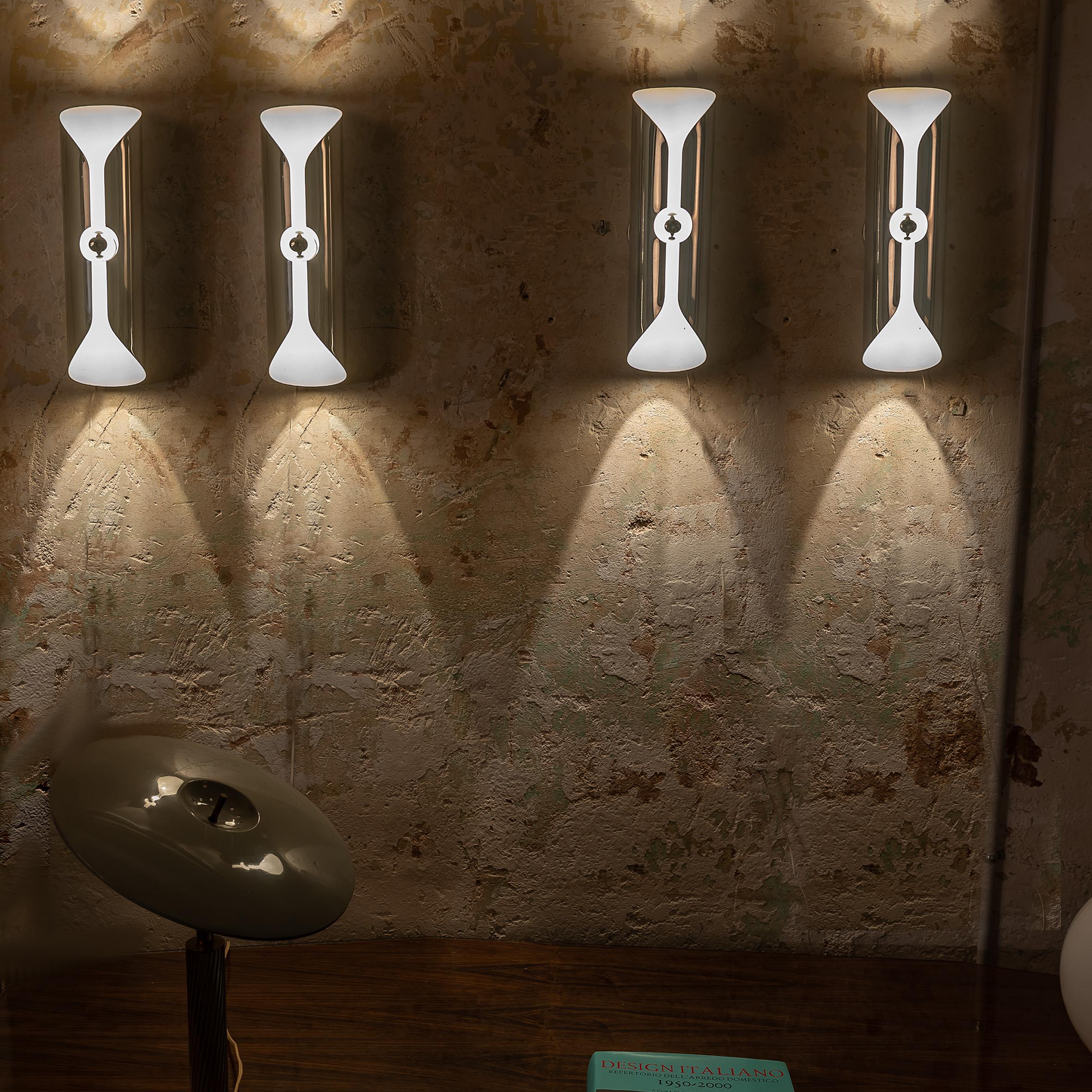 These Set of 4 Large Space Age Chrome & White Enamel Sconces from Italy, crafted in the 1970s, are a superb investment for anyone looking to enhance their interior décor with a touch of vintage sophistication and futuristic flair. These sconces are