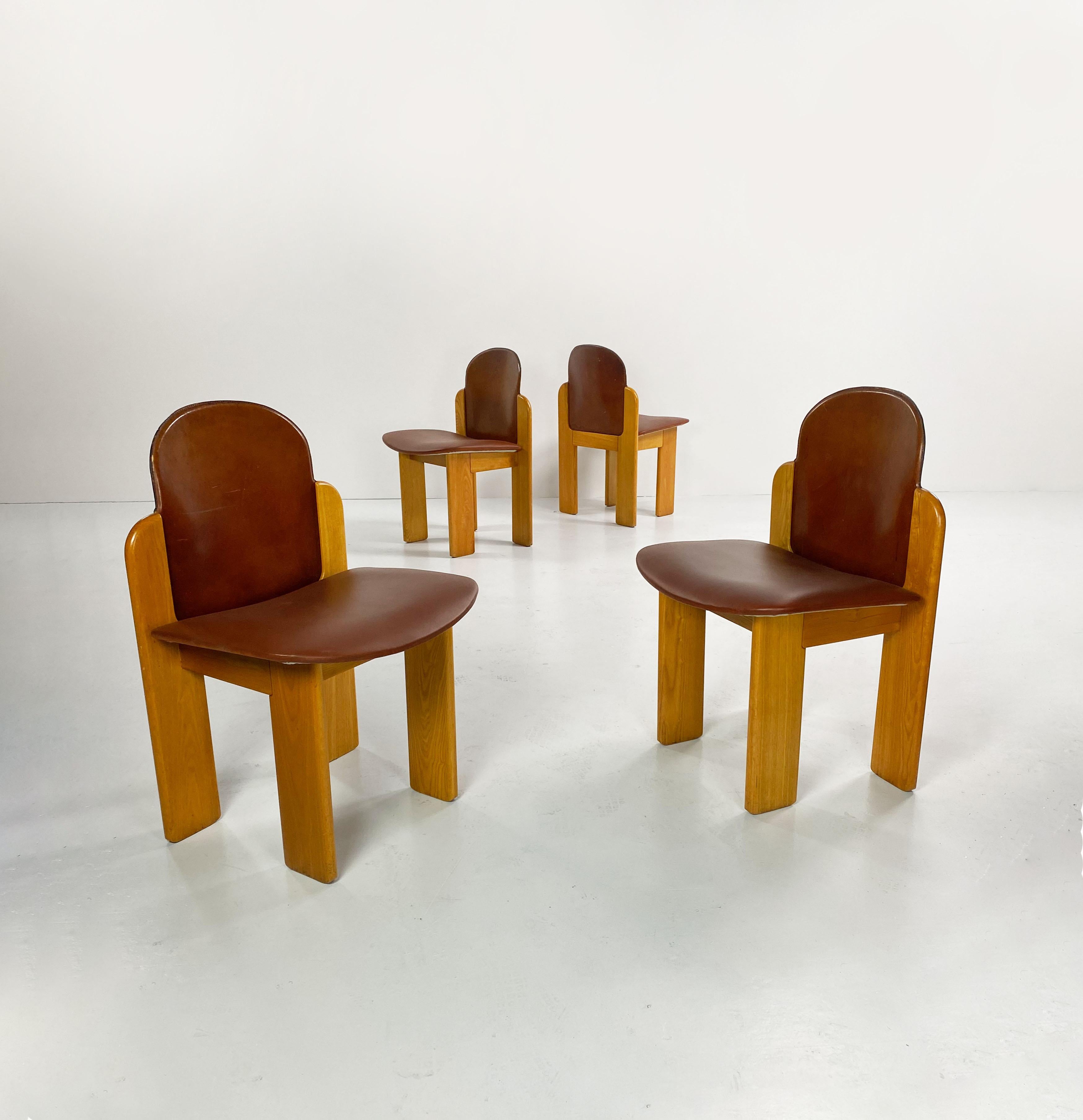 Set of 4 Model 330 cognac leather dining chairs designed by Italian architect and designer, Silvio Coppola and manufactured by Fratelli Montina in the 1970's.