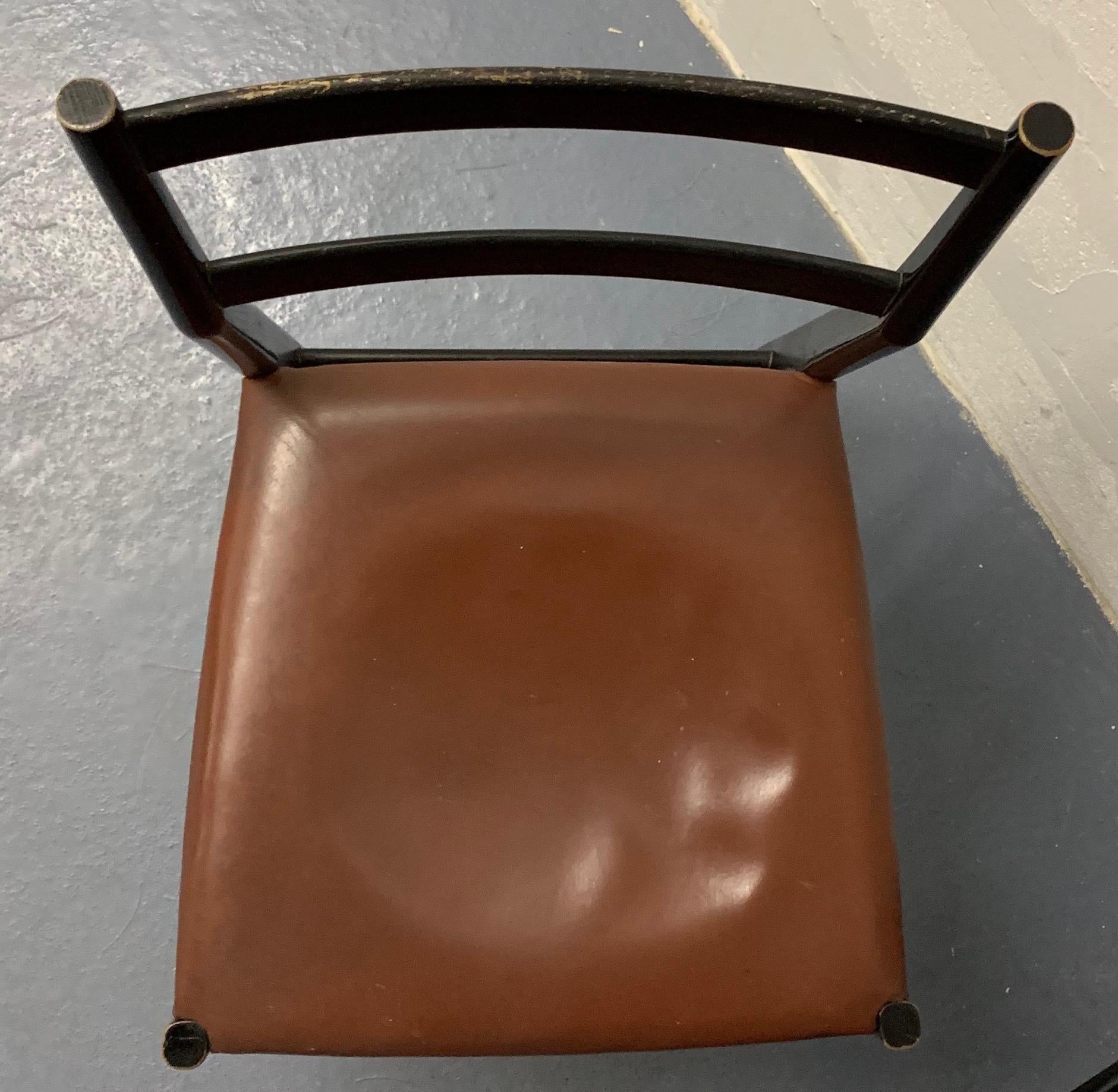 Set of 4 Gio Ponti leggera chairs in untouched original condition. Black lacquered wood bases and brown leather seats. Signes of 60 years of regular use. Fabric on the underside of the seat is defect .