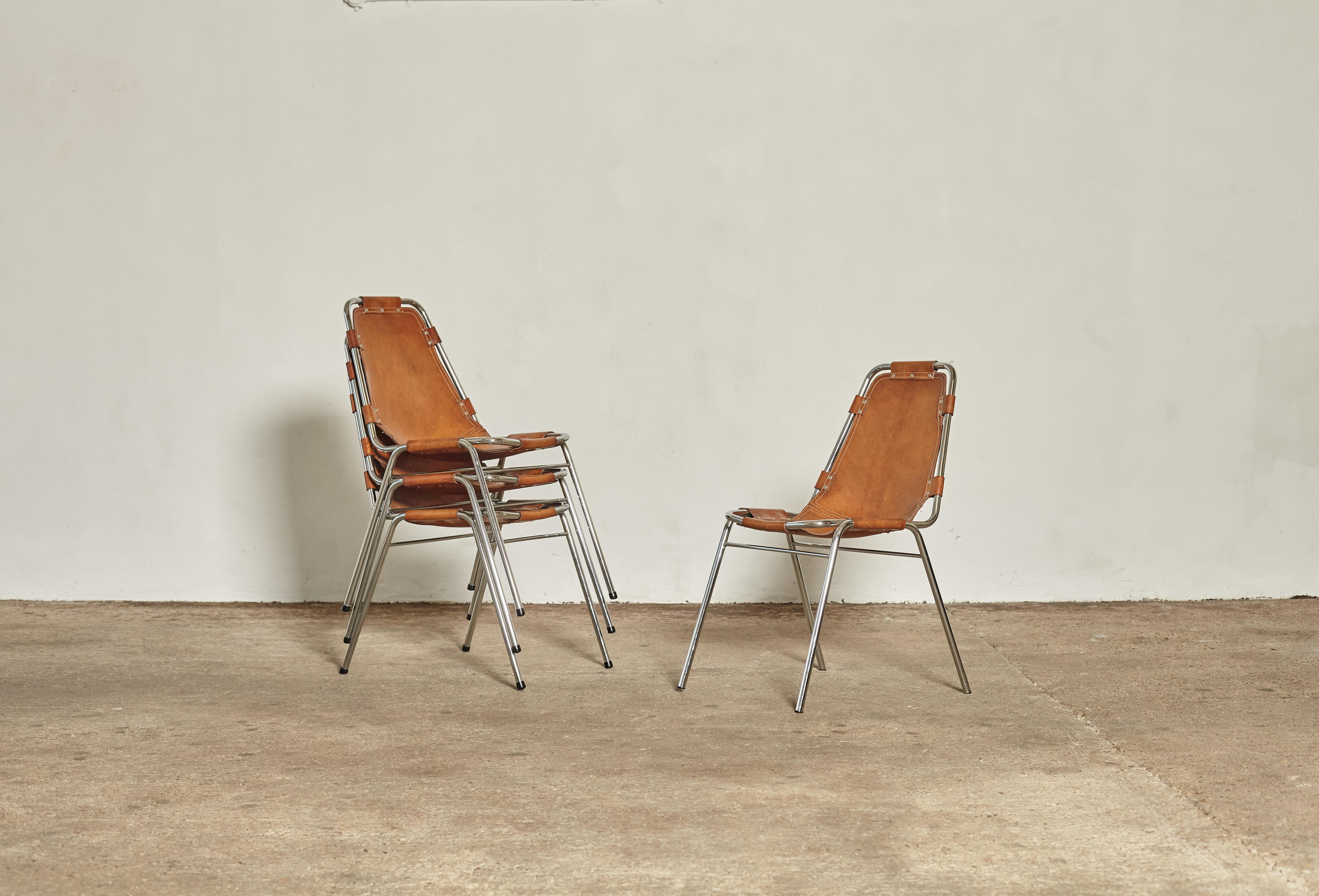 'Les Arcs' chairs in tubular steel and cognac leather, France or Italy, 1970s. Lightly patinated original leather. All original stitching intact which is rare. Very fine examples.

Les Arcs was a project on which Charlotte Perriand collaborated