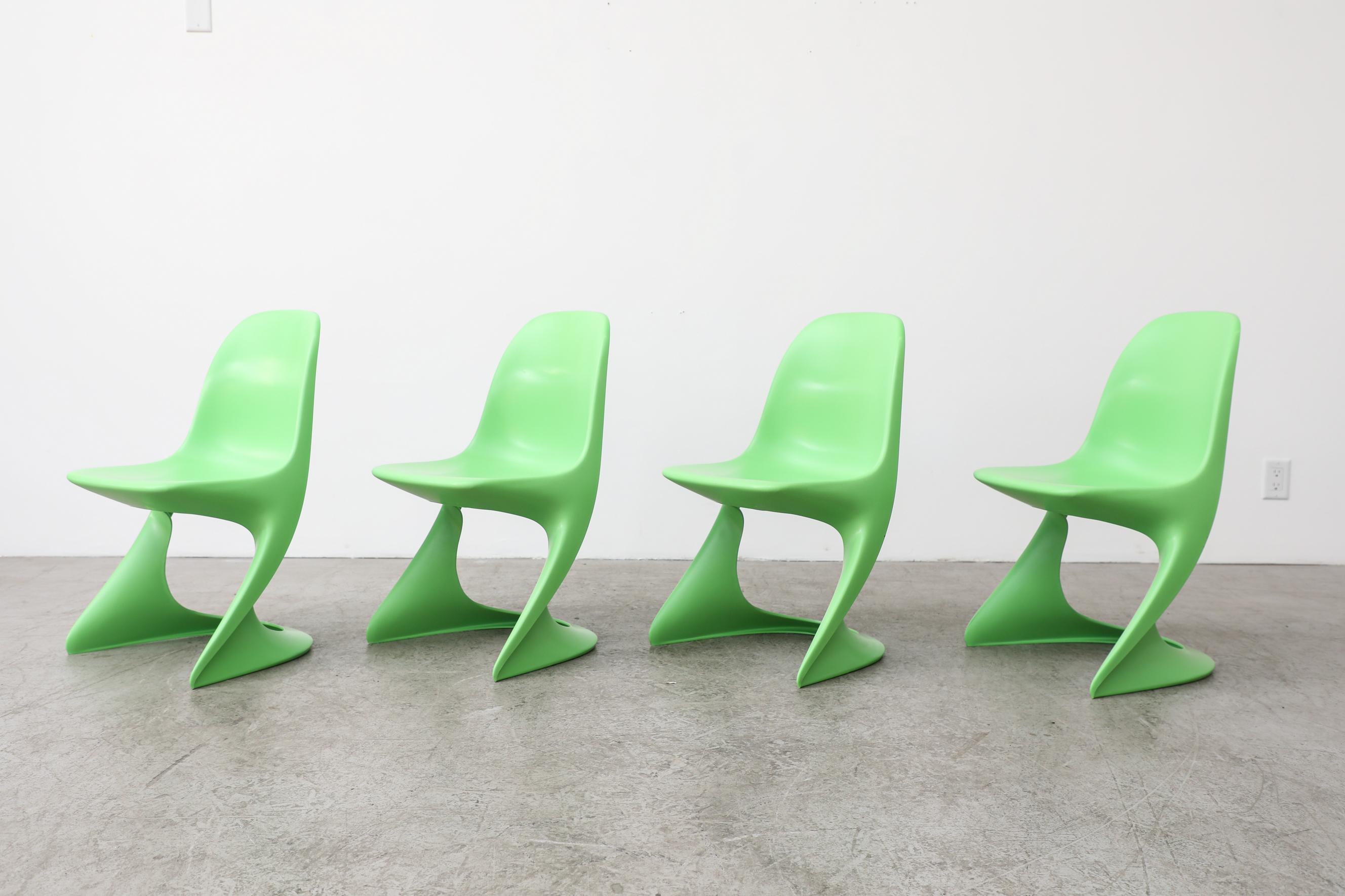 Set of four 1970's lime green plastic stacking Casalino Chairs by Alexander Begge. In original condition with visible wear, including scratching. Wear is consistent with their age and use. Two sets of 6 in white available, other colors also