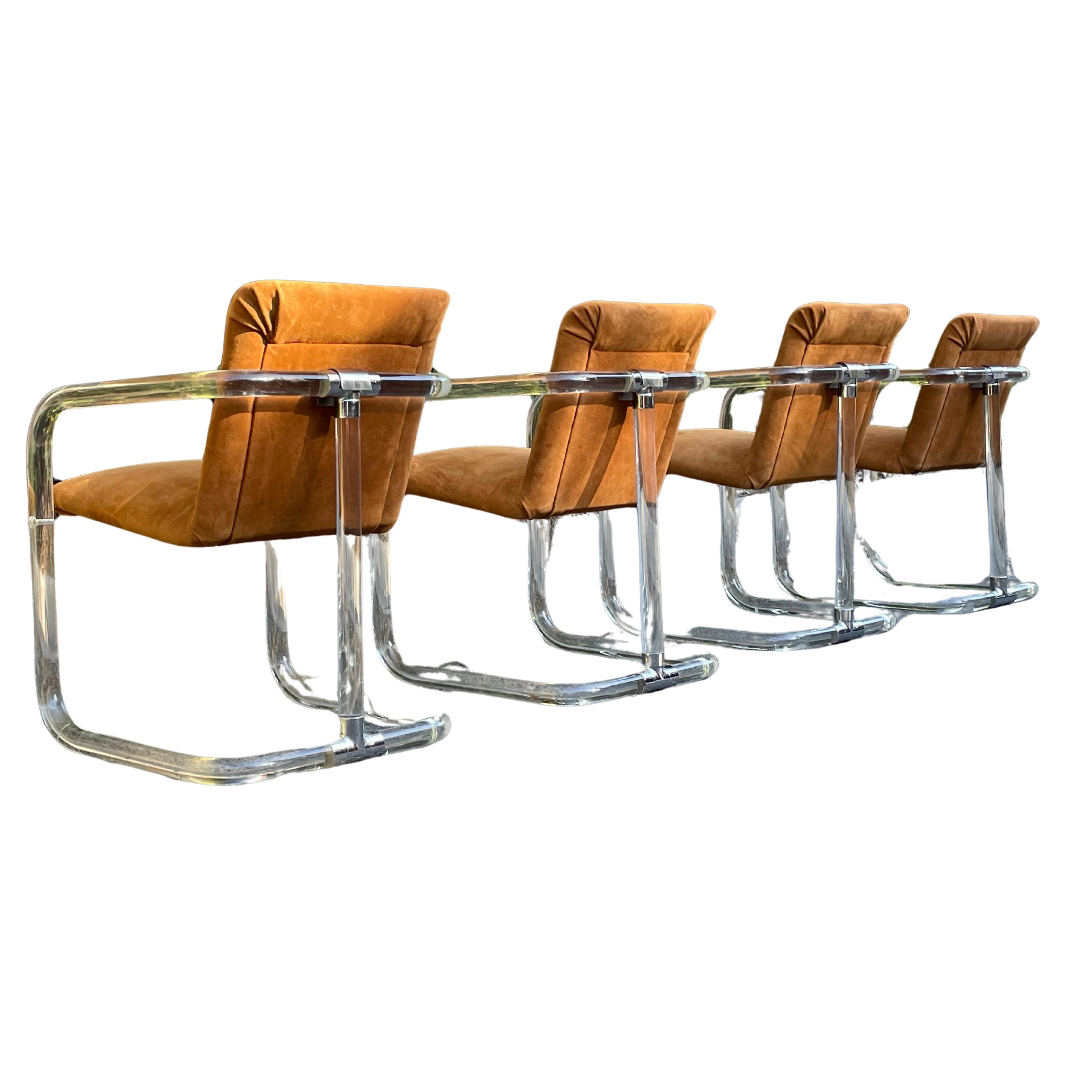 This gorgeous set of Lion in Frost lucite, suede, and chrome armchairs feature molded tubular lucite and chrome fittings that create a 